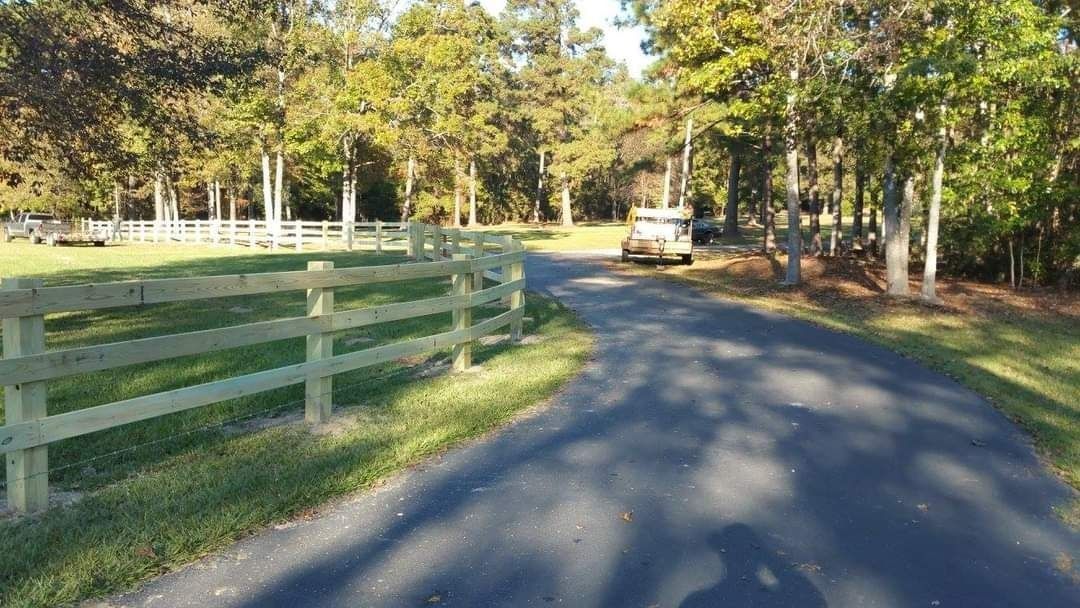 A road with a wooden fence on the side of it