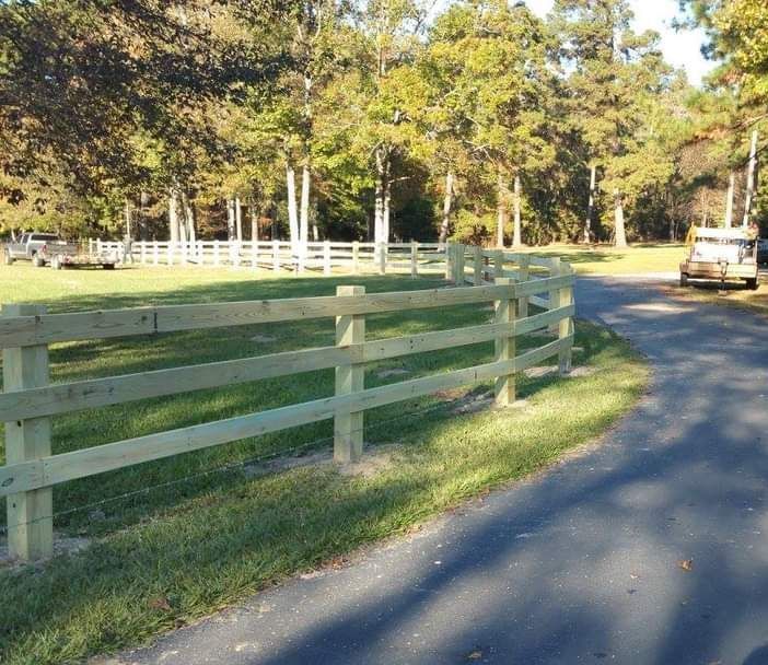 A wooden fence along the side of a road