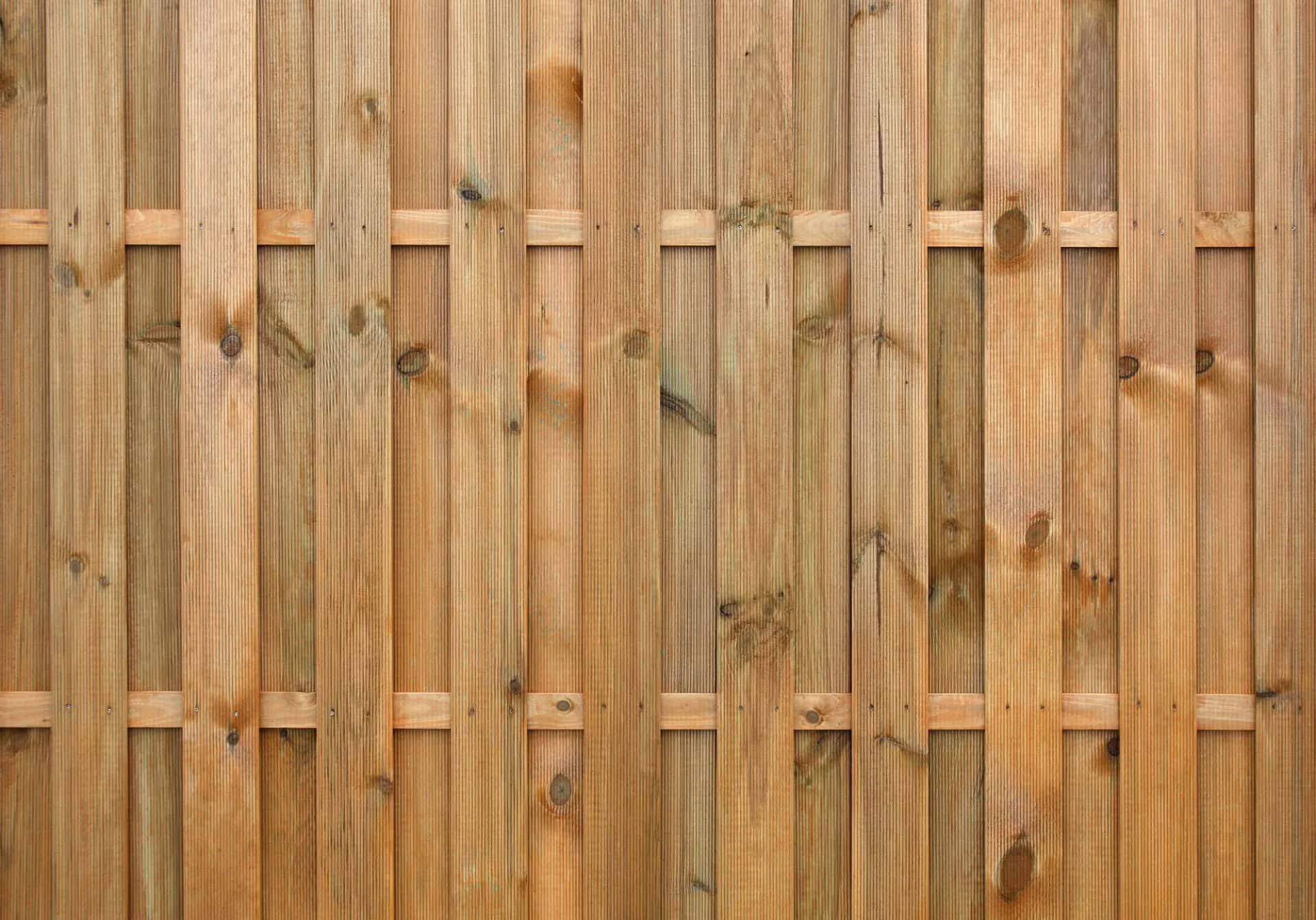 A close up of a wooden fence made of wooden planks.