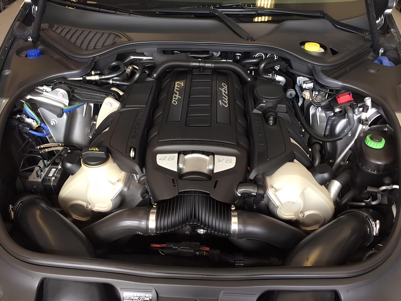 A close up of a car engine with the hood open