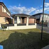 A house with a lot of grass in front of it in a residential area.