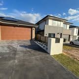 A couple of houses with a car parked in front of them.