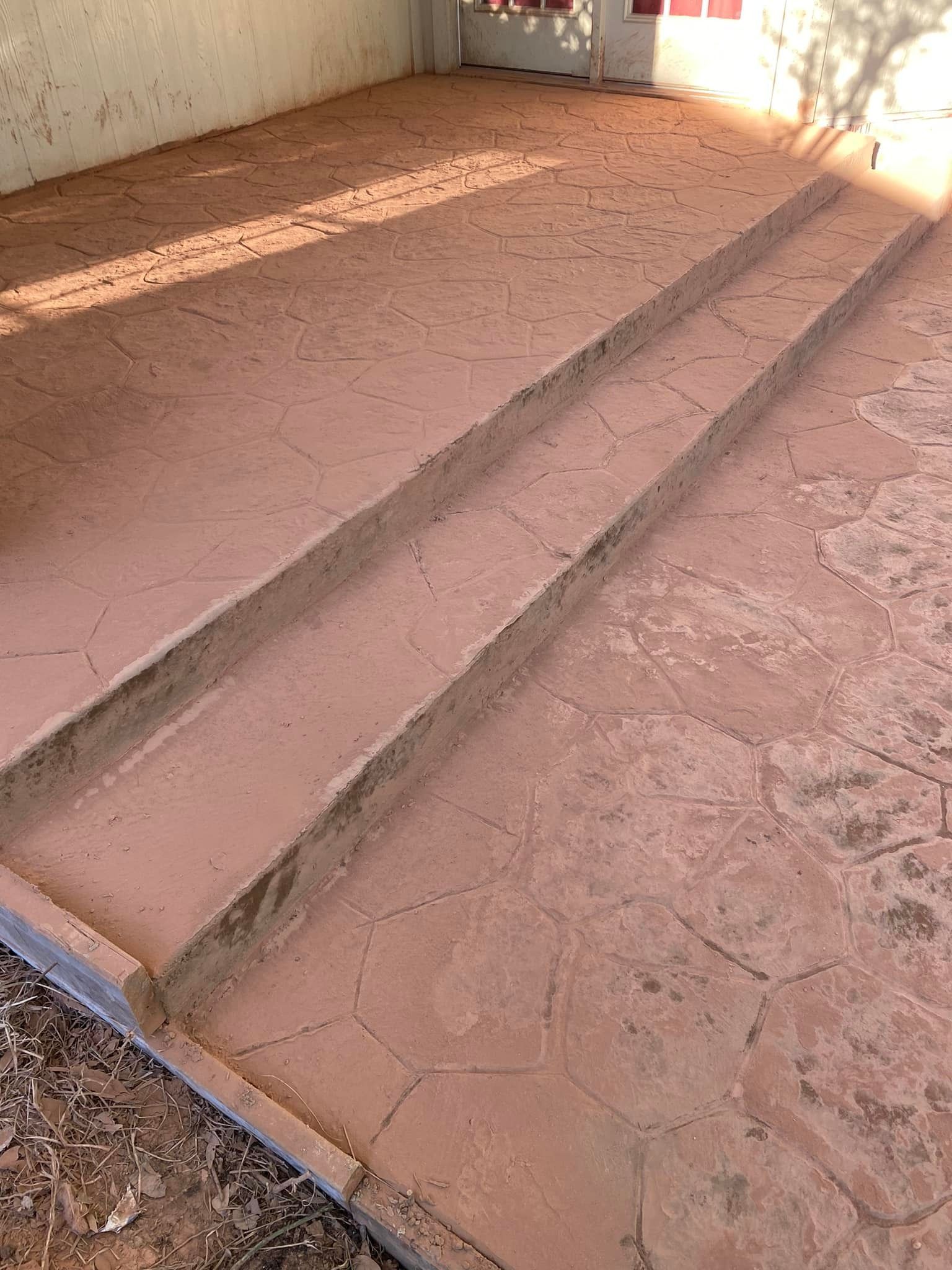 A set of concrete steps leading up to a building.