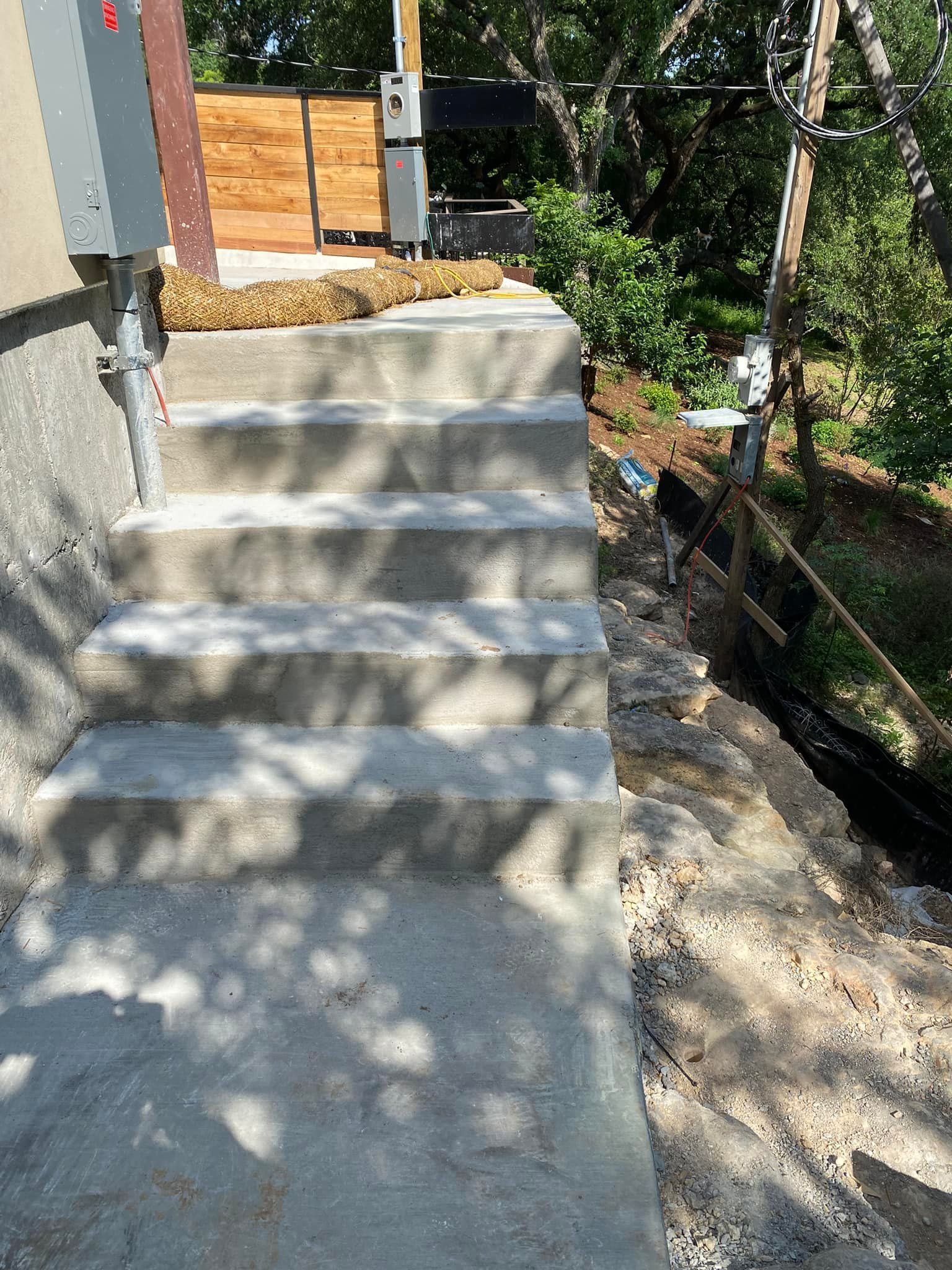 A set of concrete stairs leading up to a house.