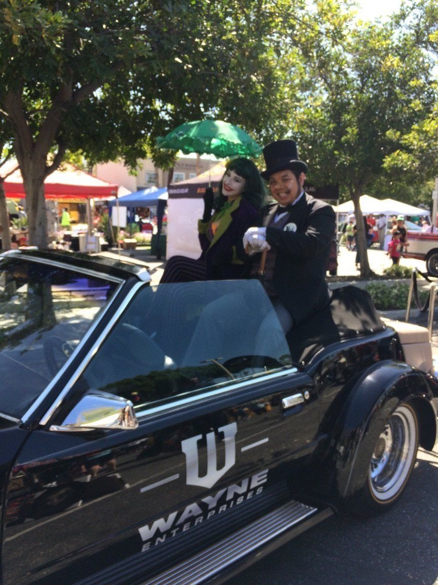 Couple in formal wear riding in a black car with 