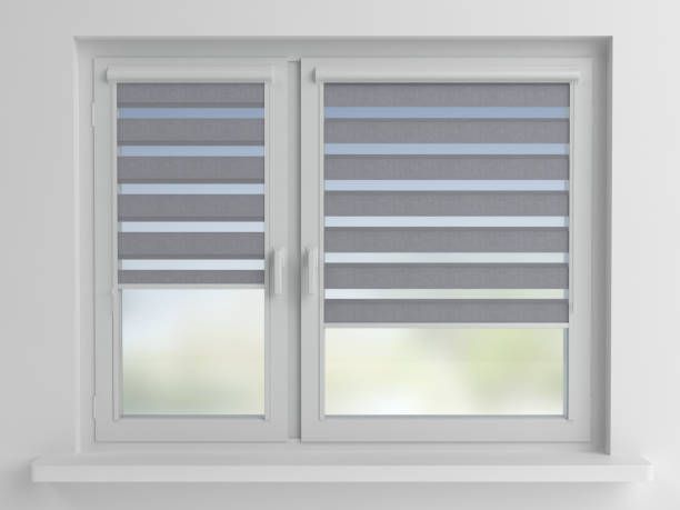 A window with a gray and white striped blind on it.