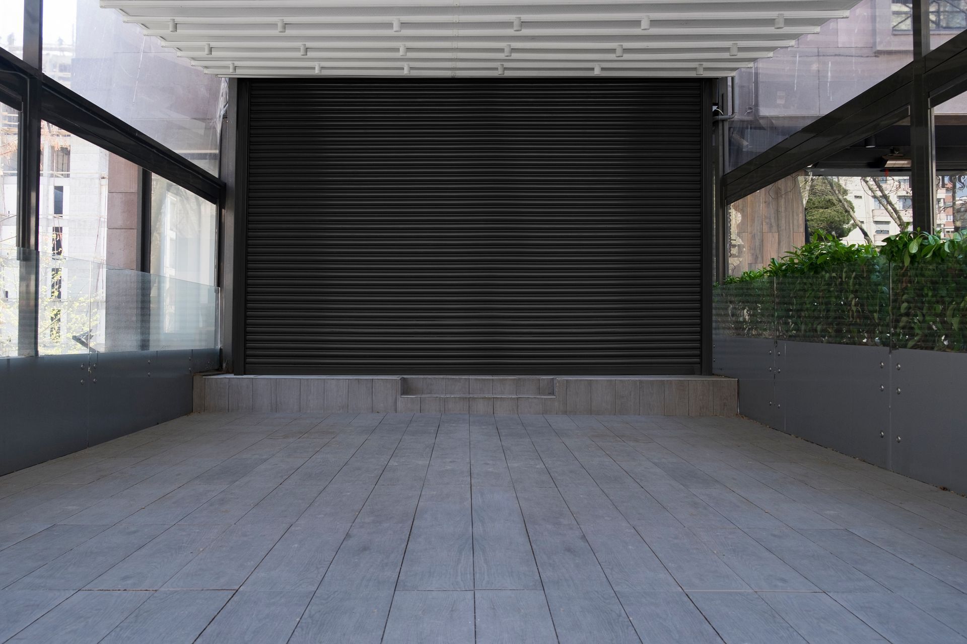 An empty parking garage with a black garage door.