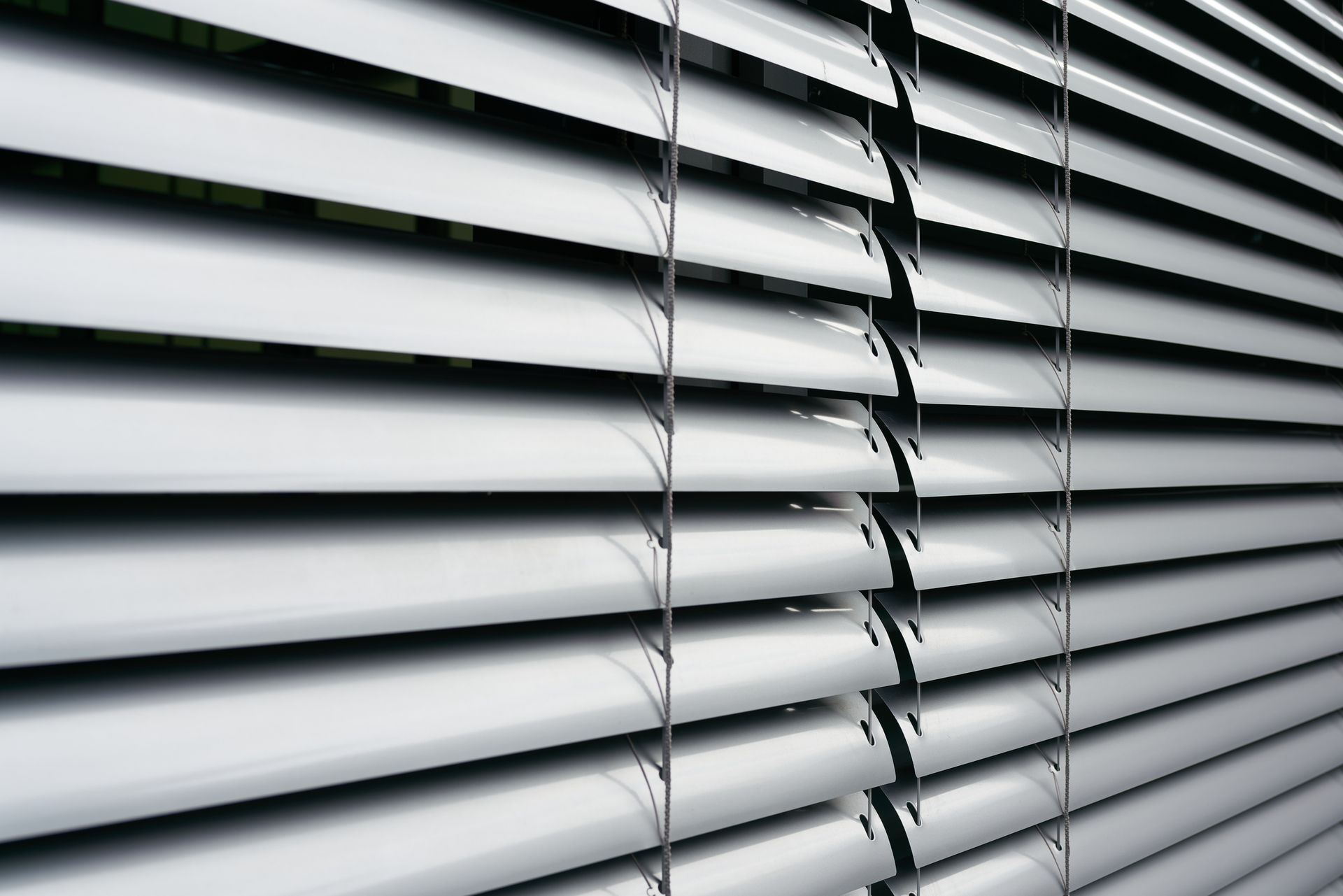 A close up of a window with blinds on it