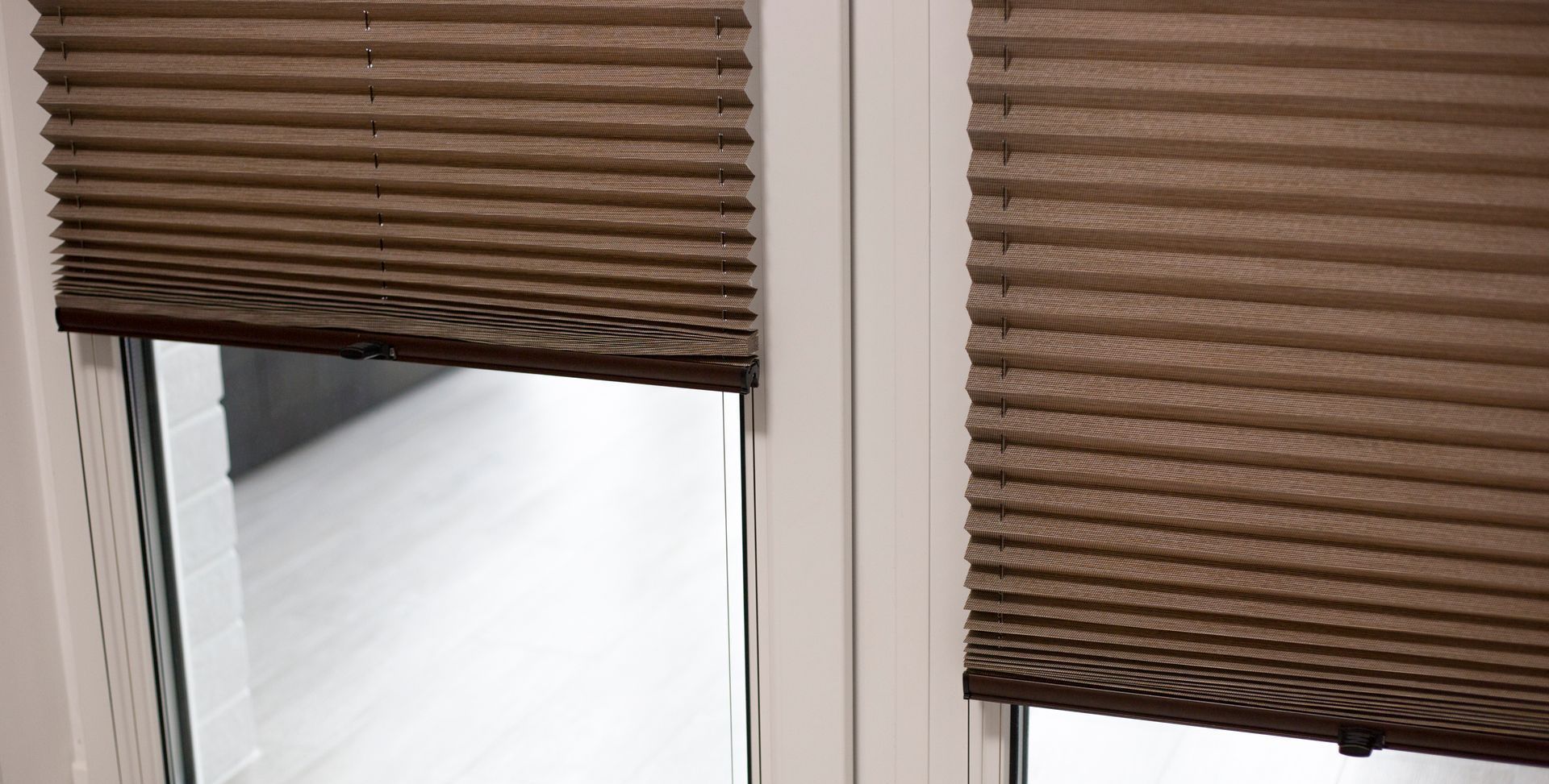 A close up of a window with blinds on it.
