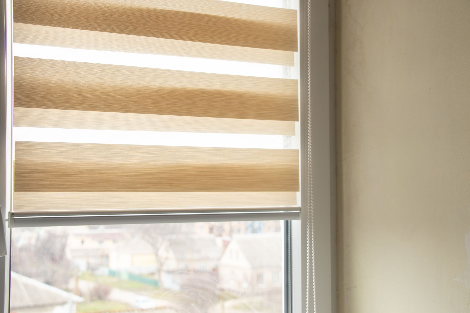 A window with a striped blind on it.