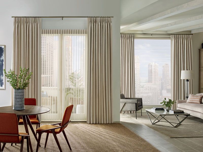 A living room with a large window and a bench in front of it.