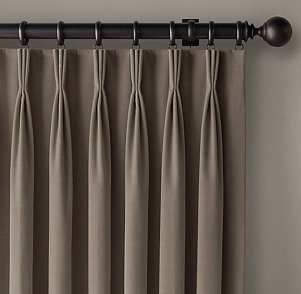 A pair of brown curtains are hanging on a window.
