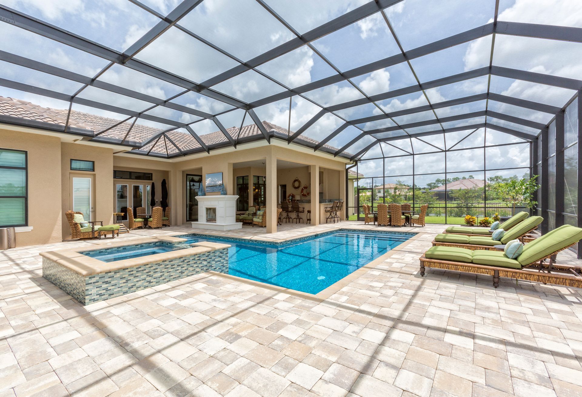 There is a large swimming pool in the backyard of a house.