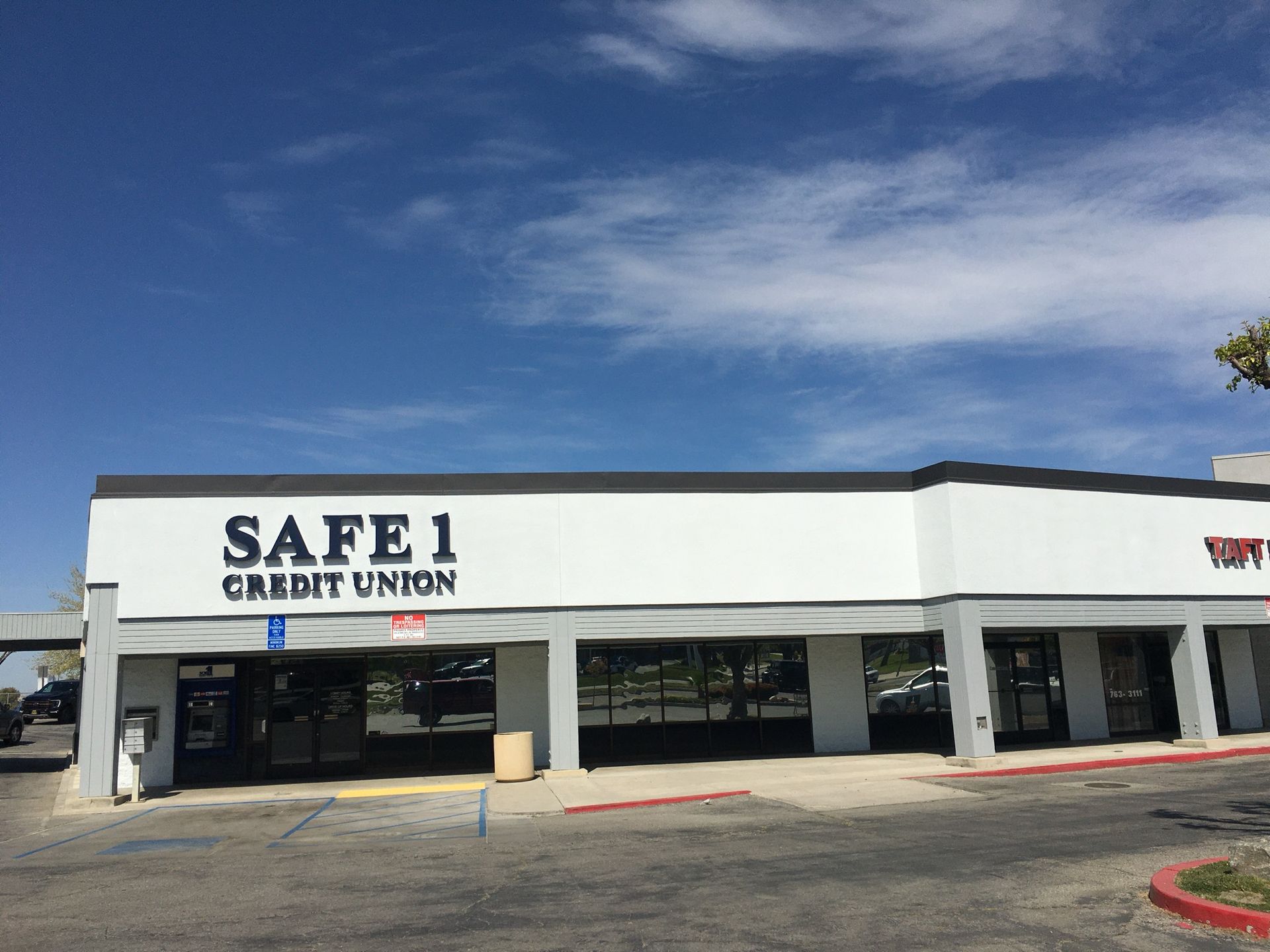 Safe 1 Credit Union building under a blue sky.