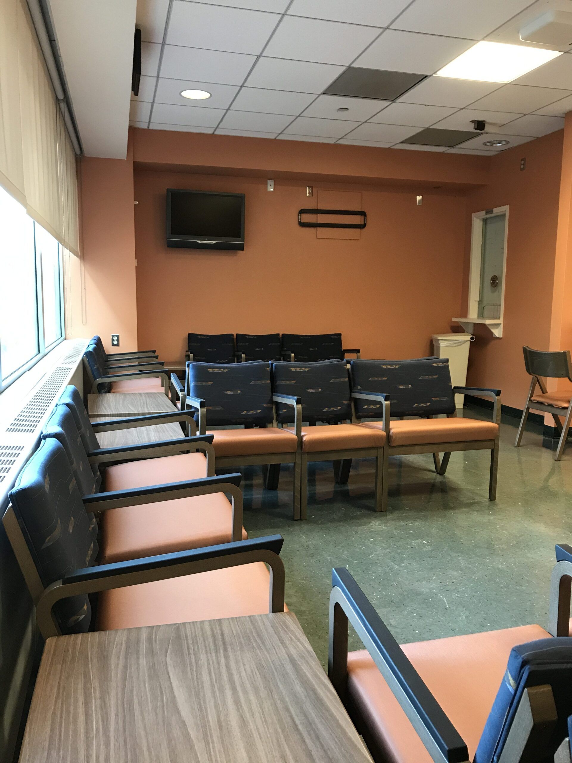 A waiting room with a lot of chairs and tables