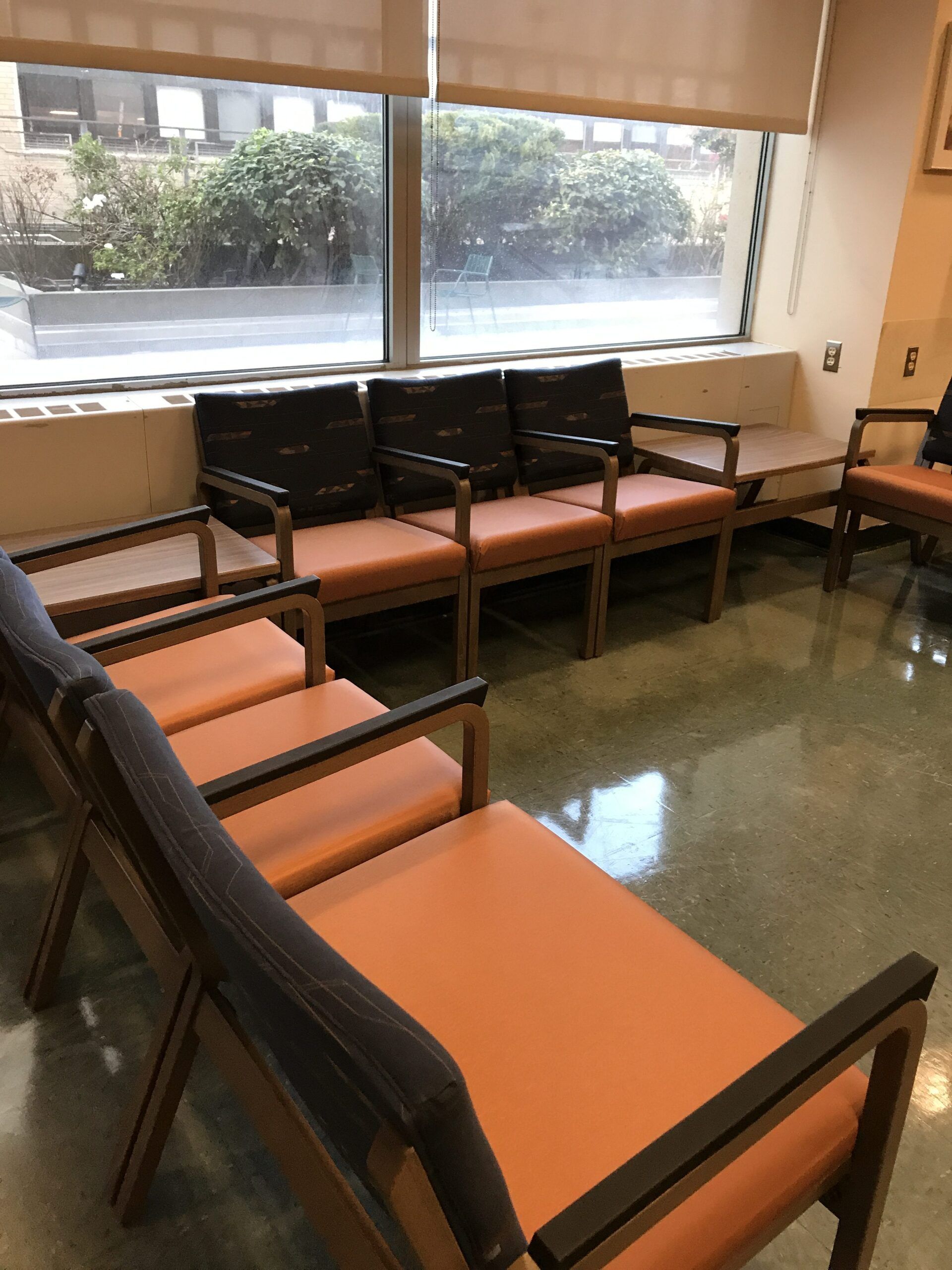 A row of chairs in a waiting room with a window