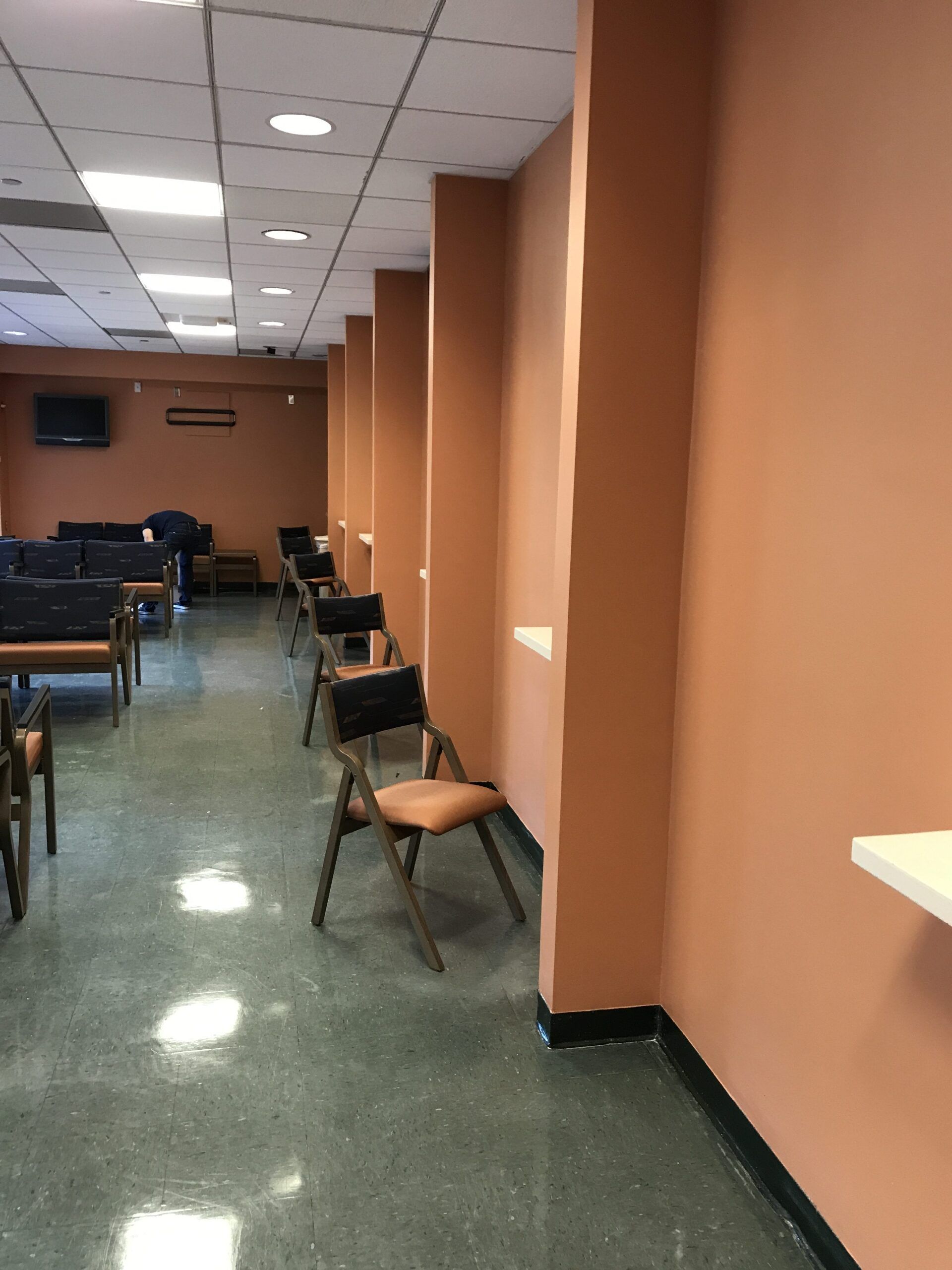 A long hallway with chairs and a couch