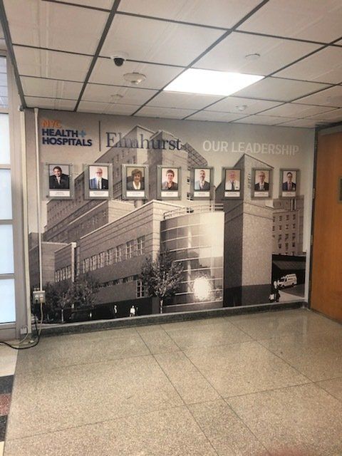 A wall with a picture of a building and the words health hospitals on it