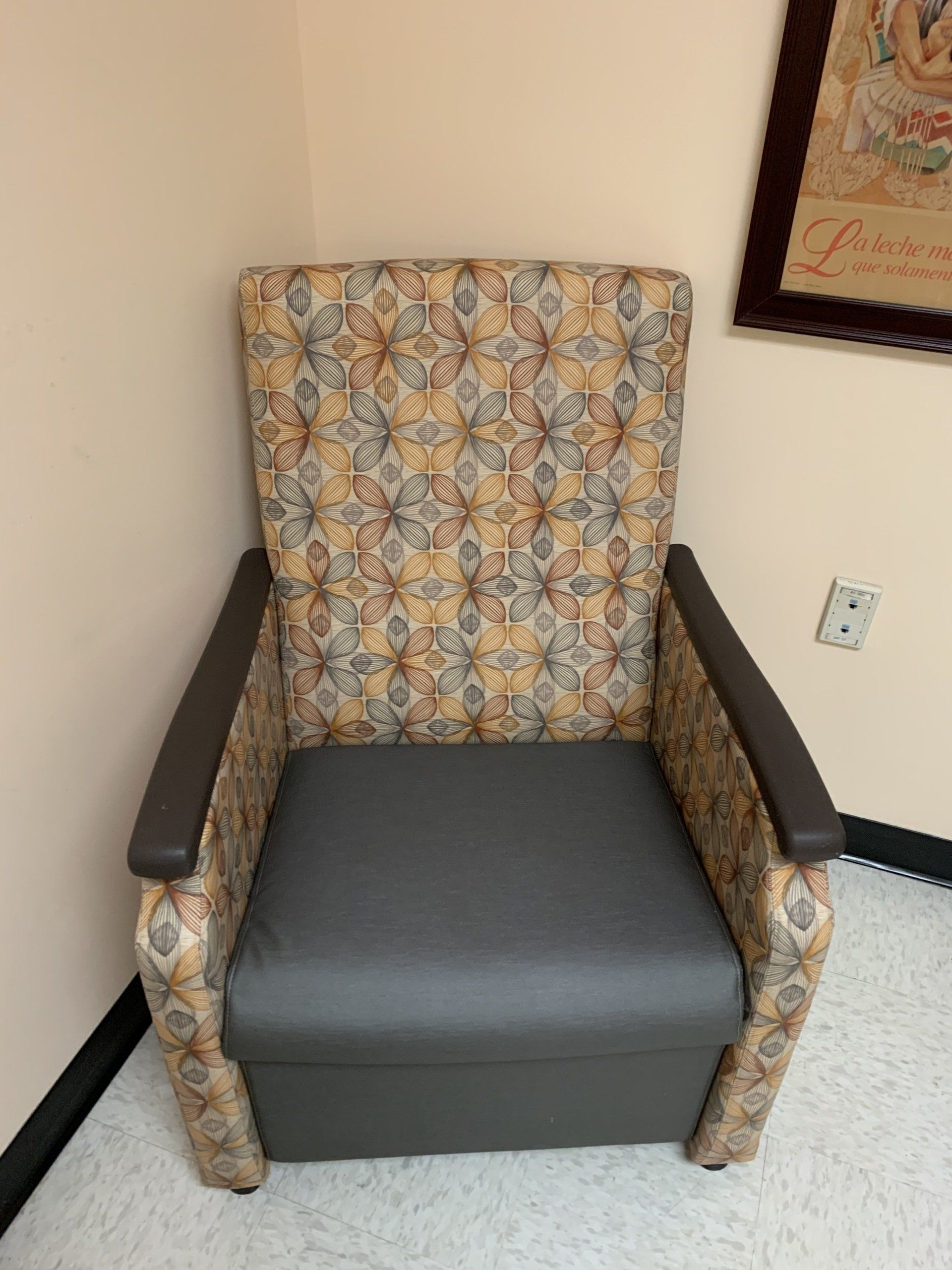 A chair in a room with a picture on the wall