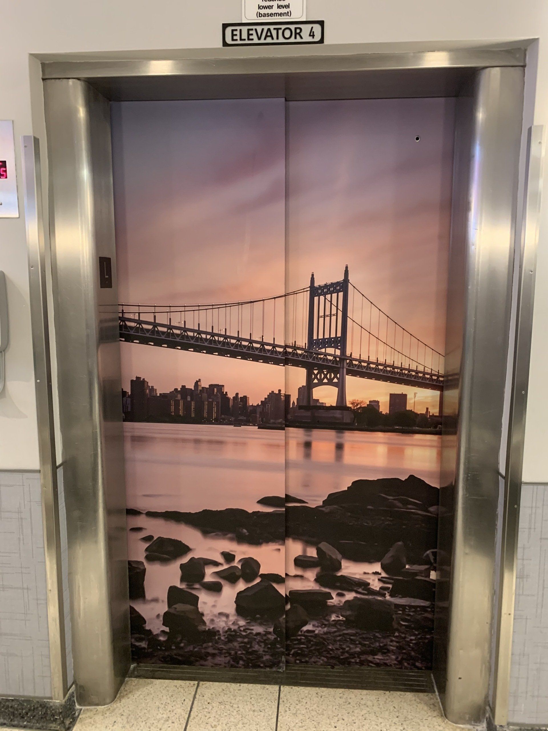 An elevator with a picture of a bridge on it