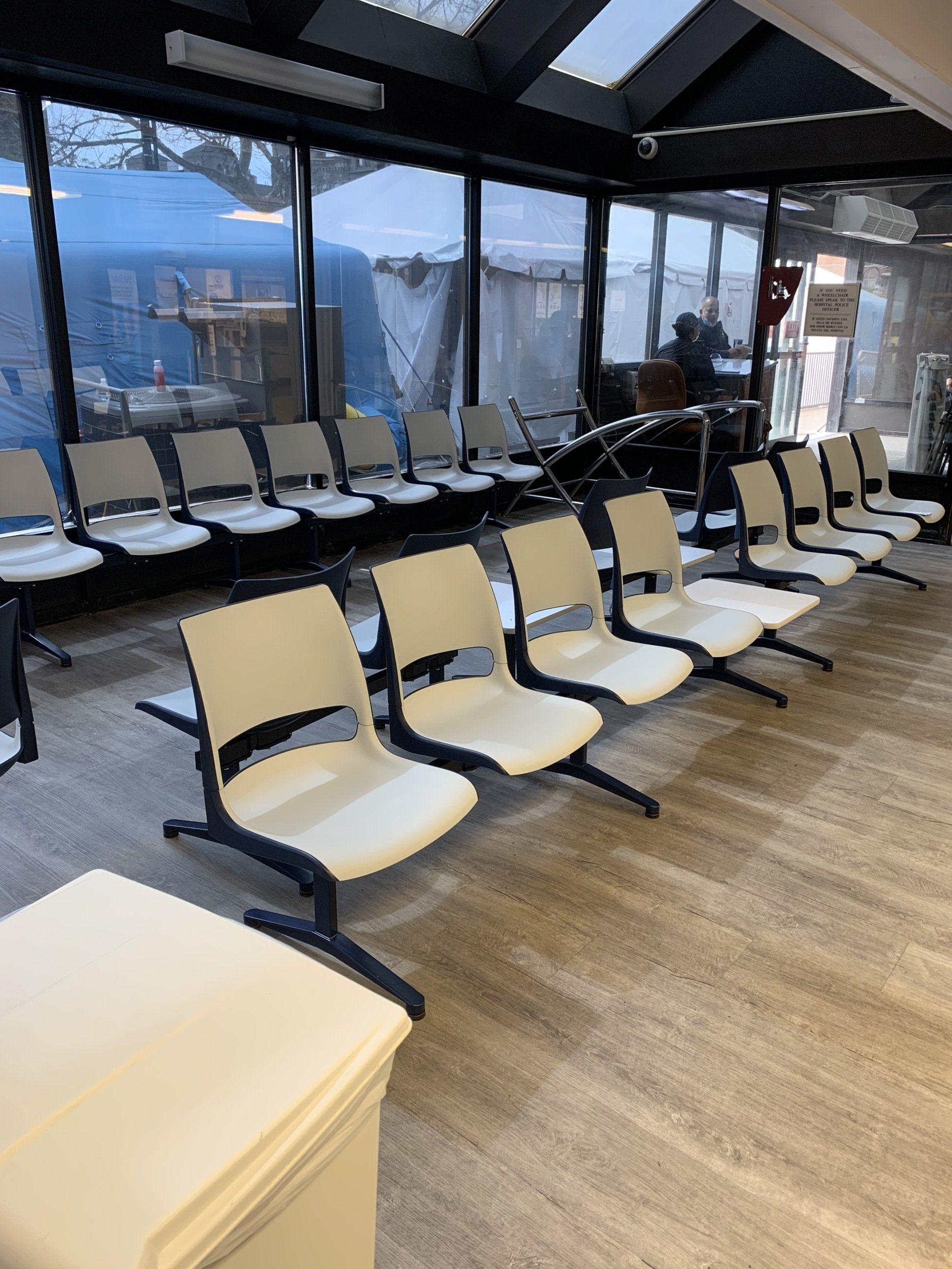 A row of white chairs in a waiting room