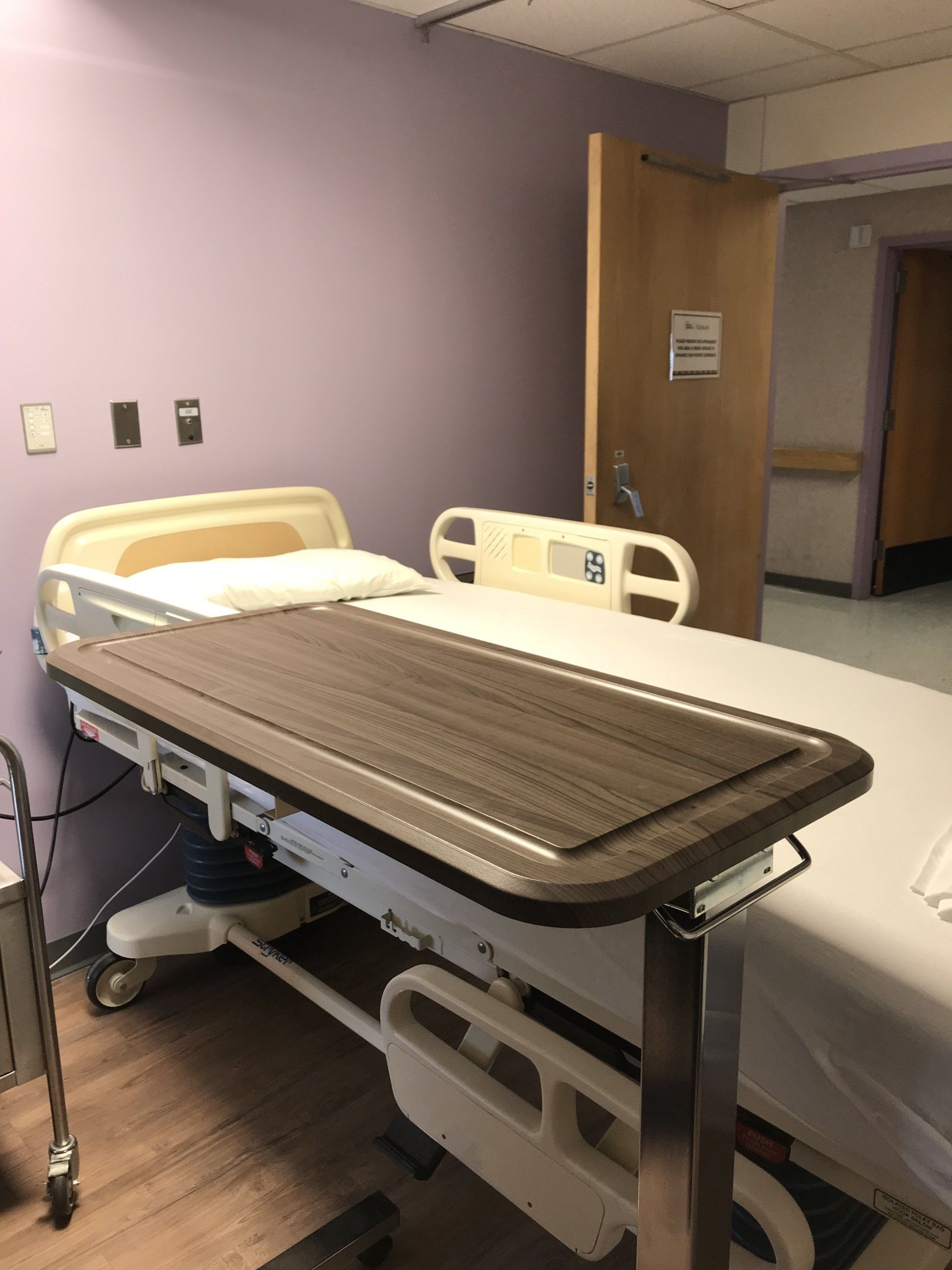 A hospital room with two beds and a table