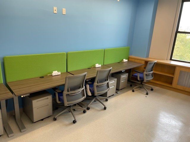 A room with a lot of desks and chairs in it