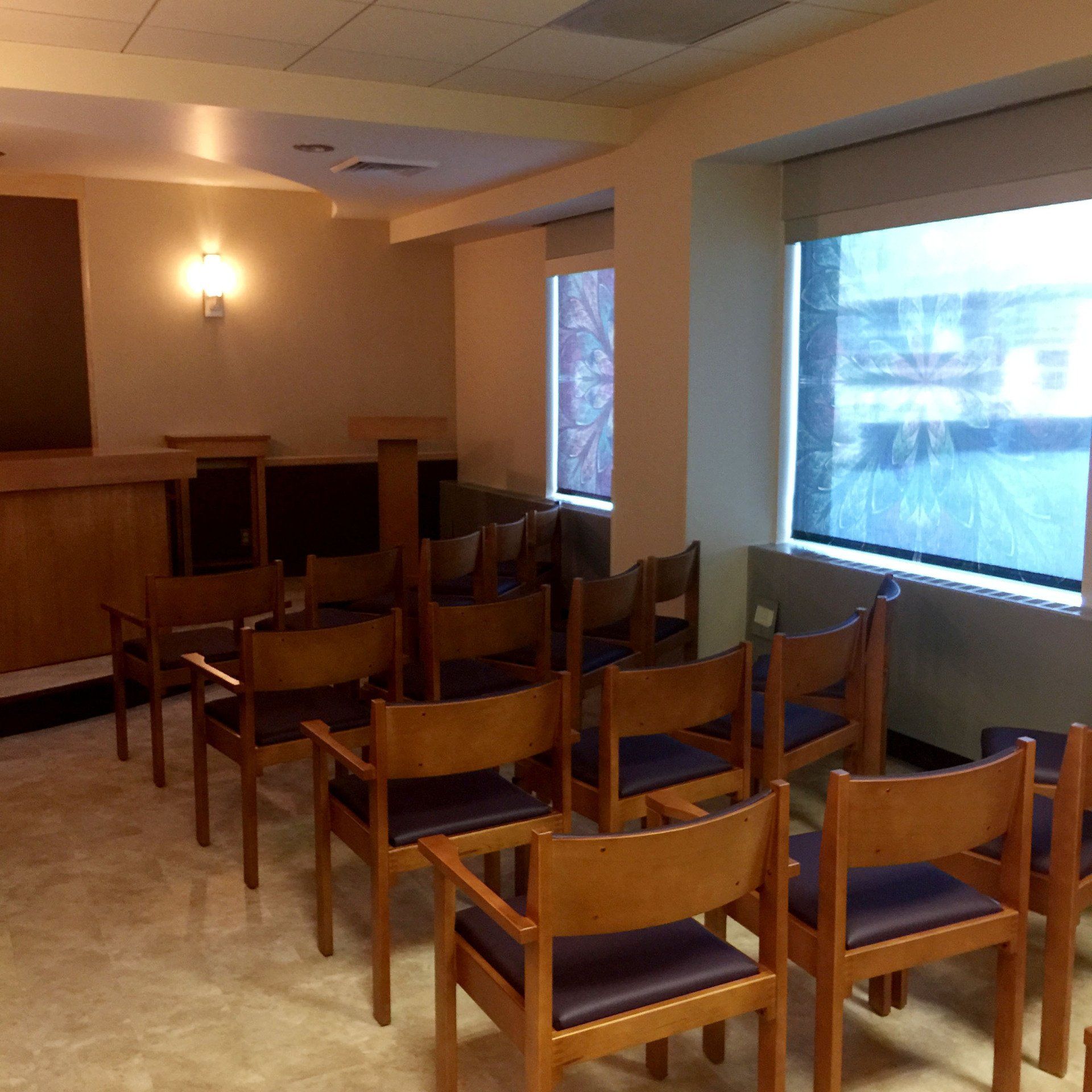 A room with a lot of chairs and a window