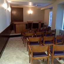 A room filled with wooden chairs and a table.