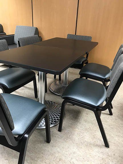 A room with a table and chairs in it