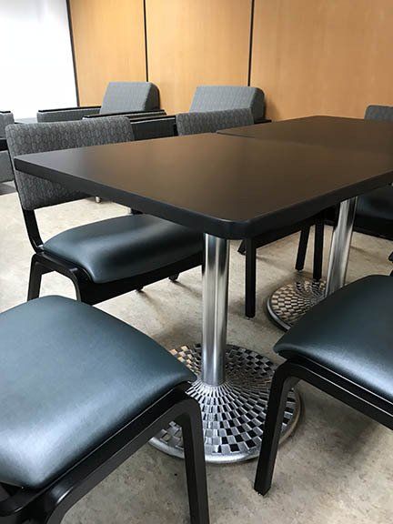 A room with a table and chairs in it