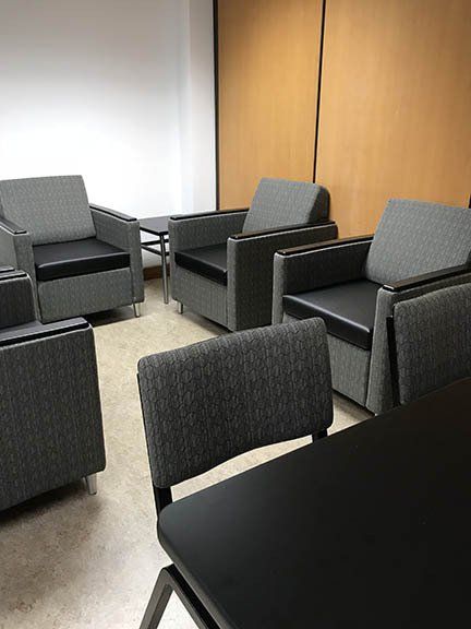 A room with chairs and a table in it