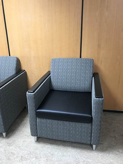 Two chairs are sitting next to each other in a room.