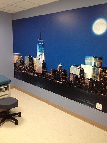 A room with a picture of a city skyline on the wall