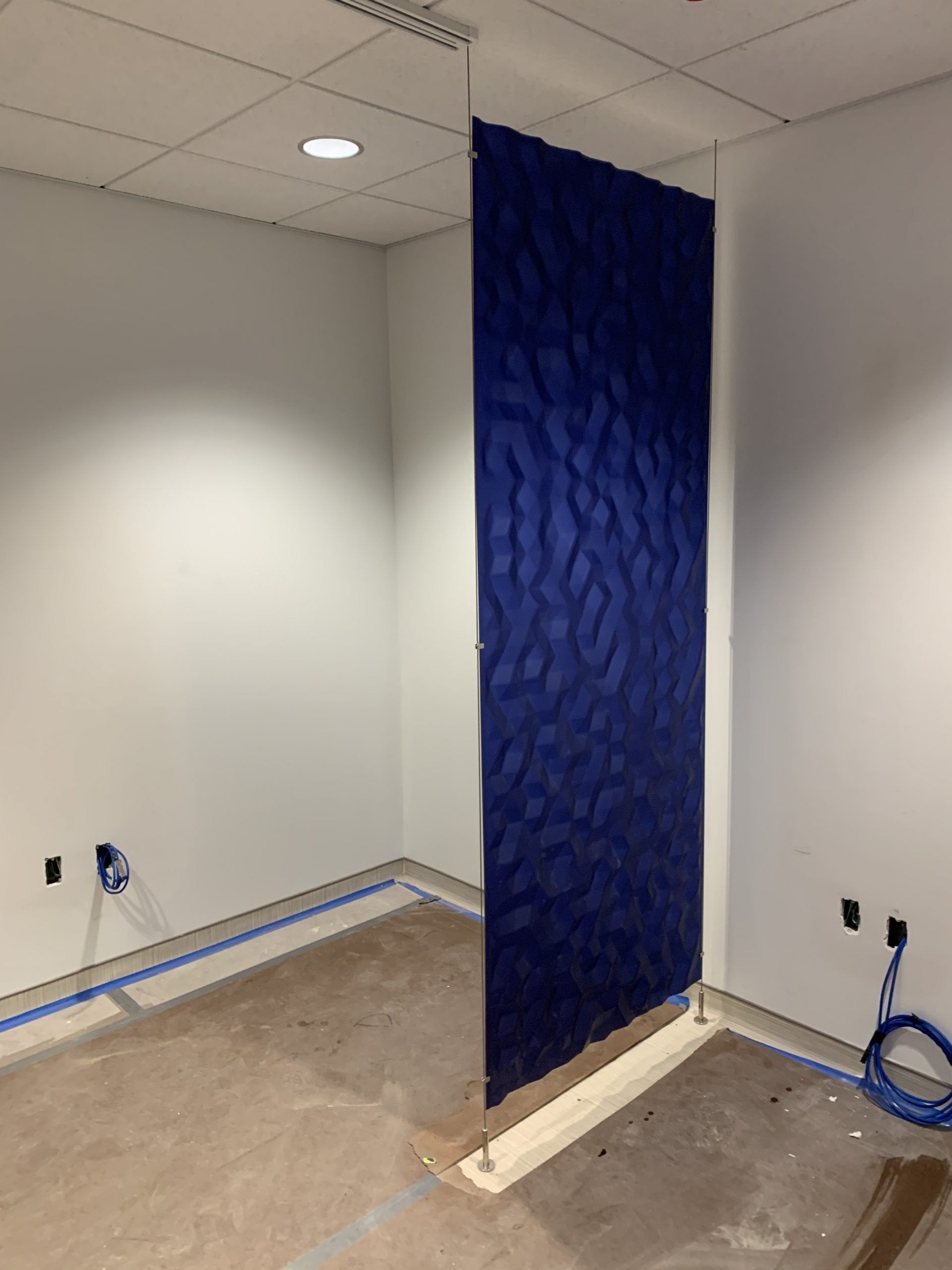 A room with white walls and a blue divider