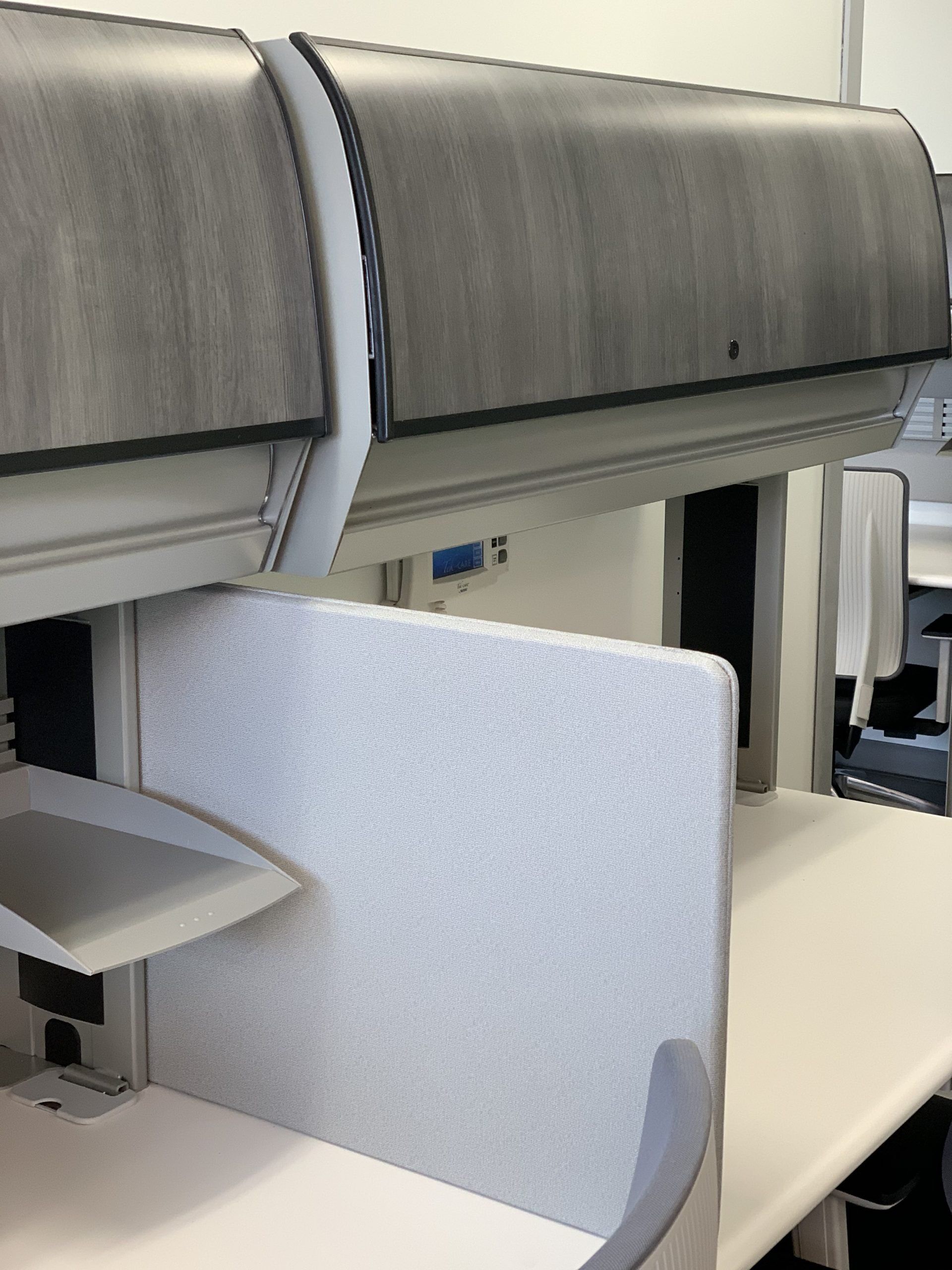 A white desk with a shelf underneath it