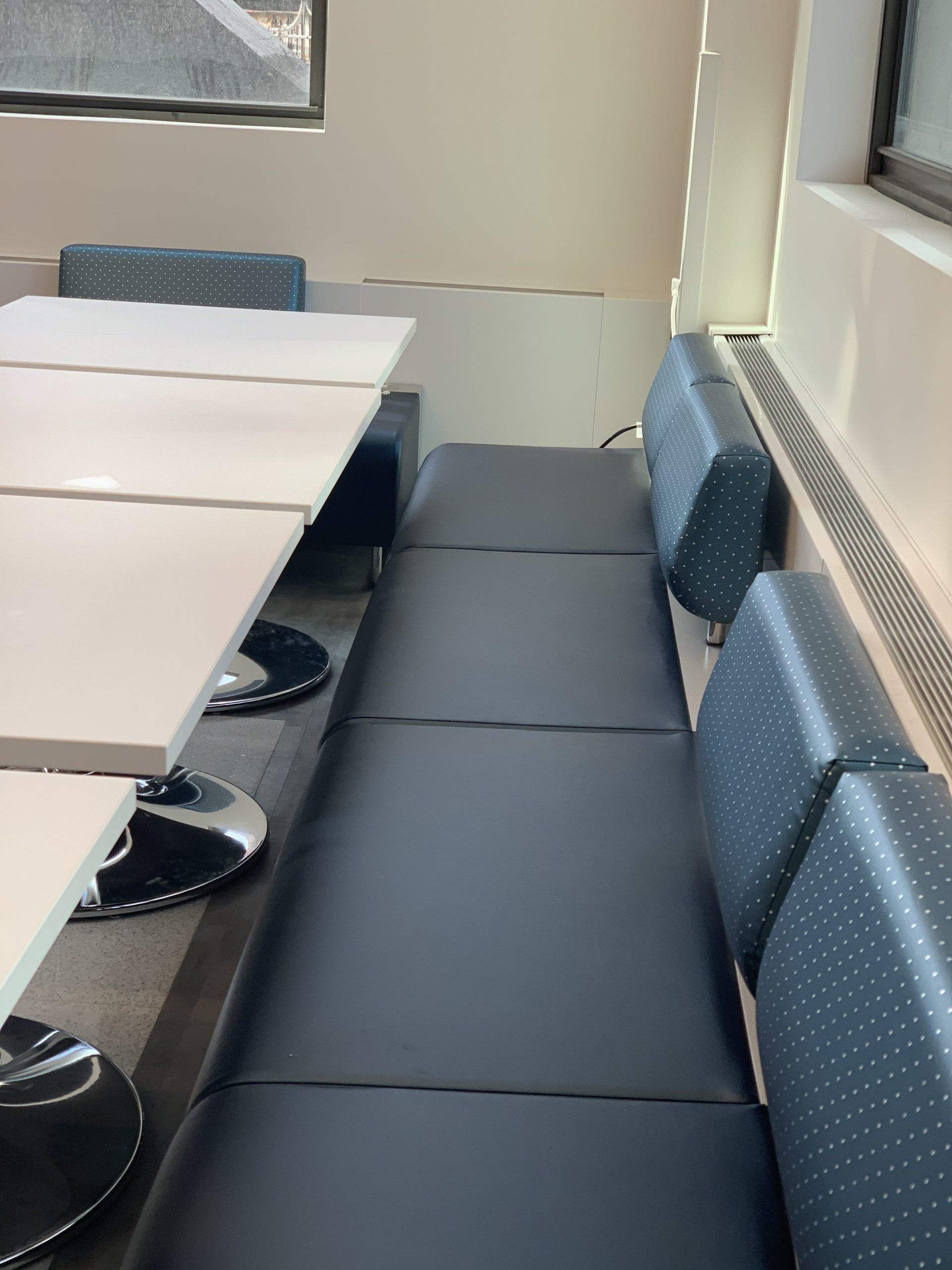 A room with tables and chairs and a window