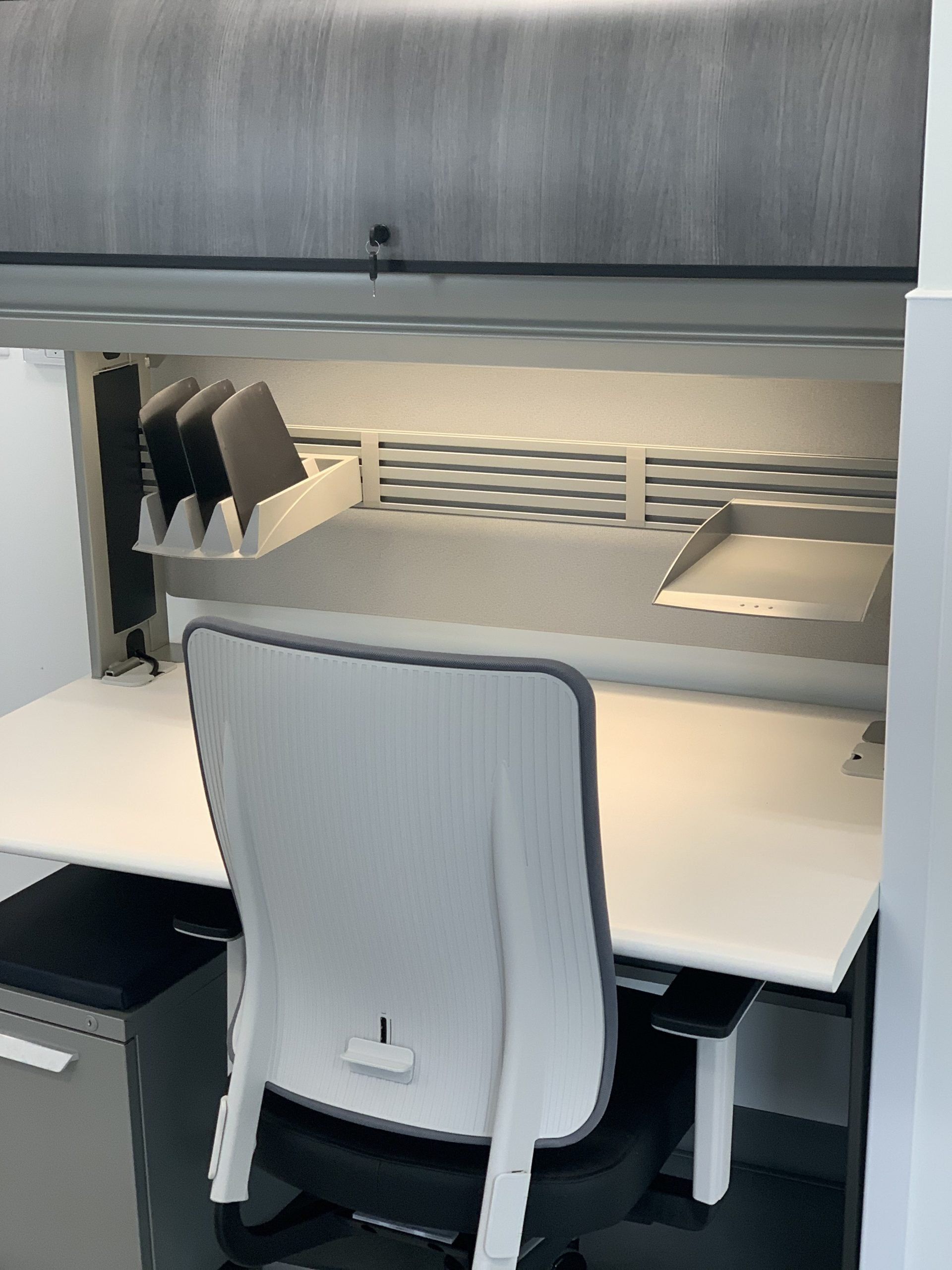 A white desk with a black chair in front of it