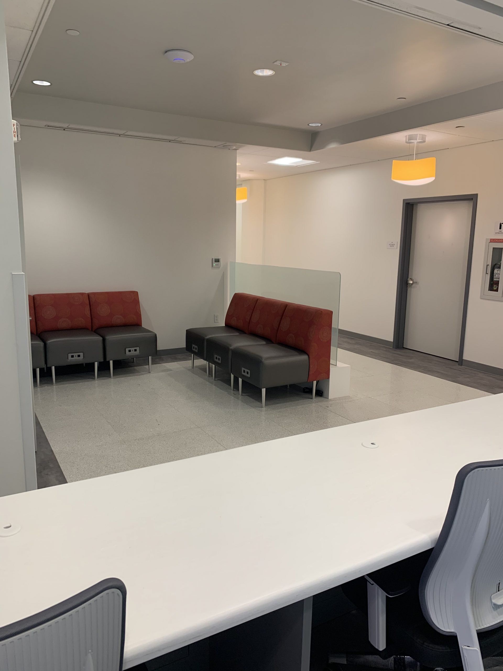 A waiting room with a couch and chairs in it