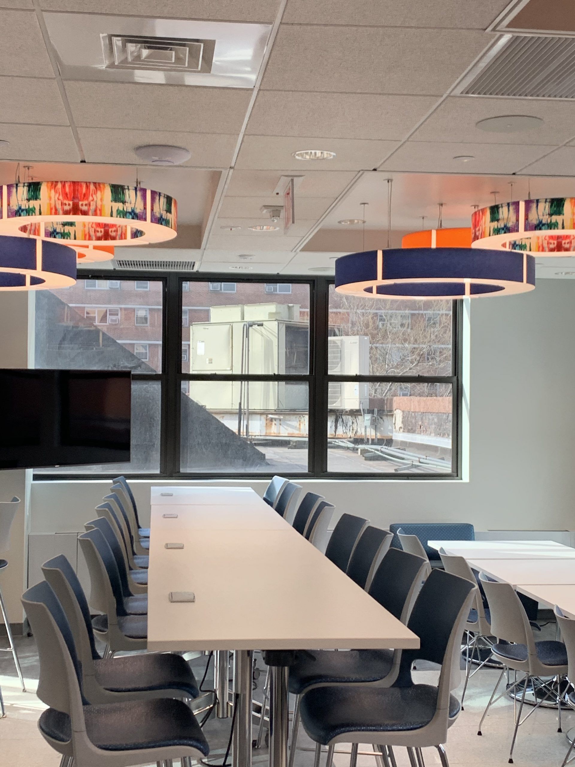 A dining room with a long table and chairs