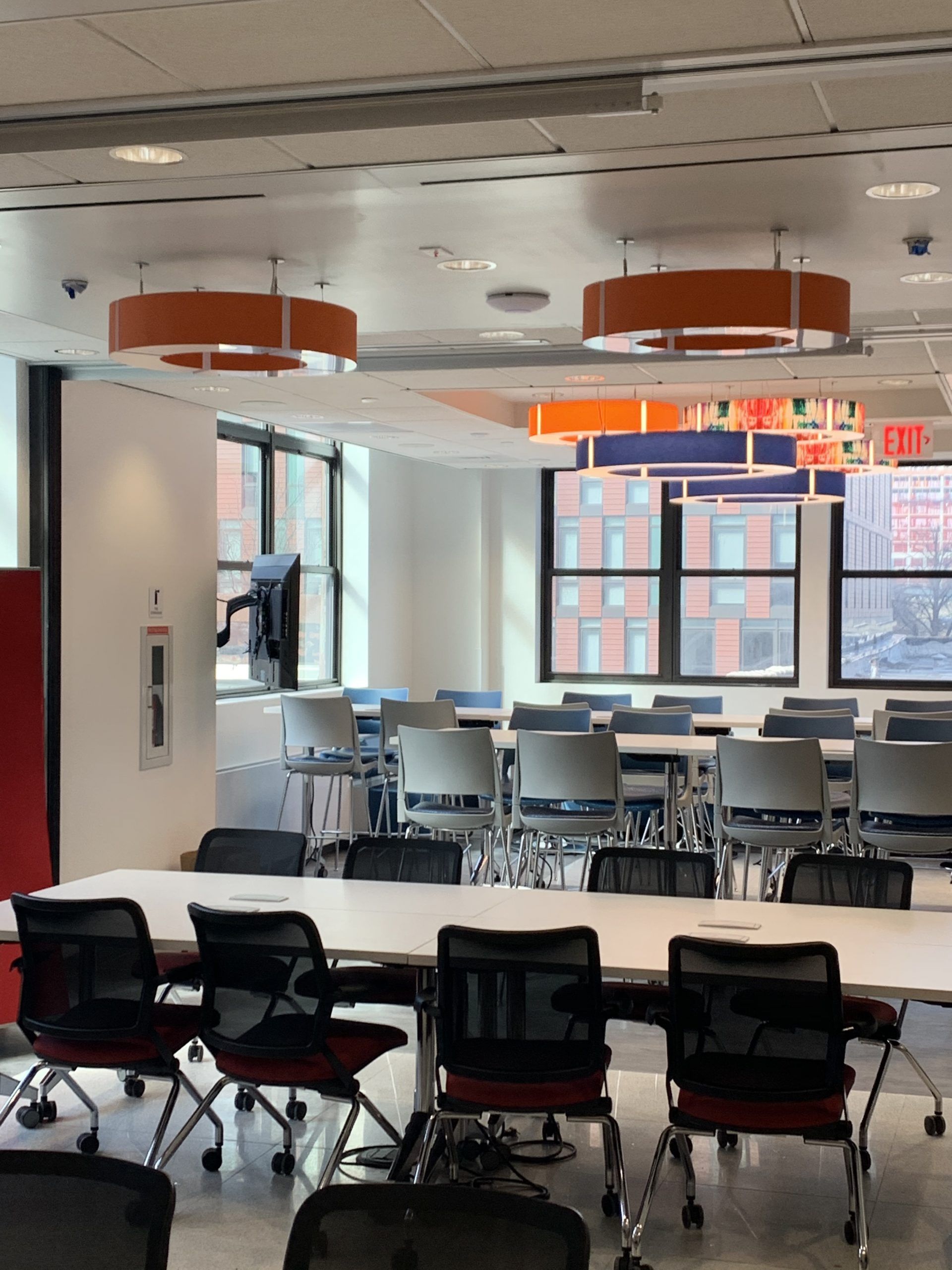 A room with tables and chairs and a sign that says exit