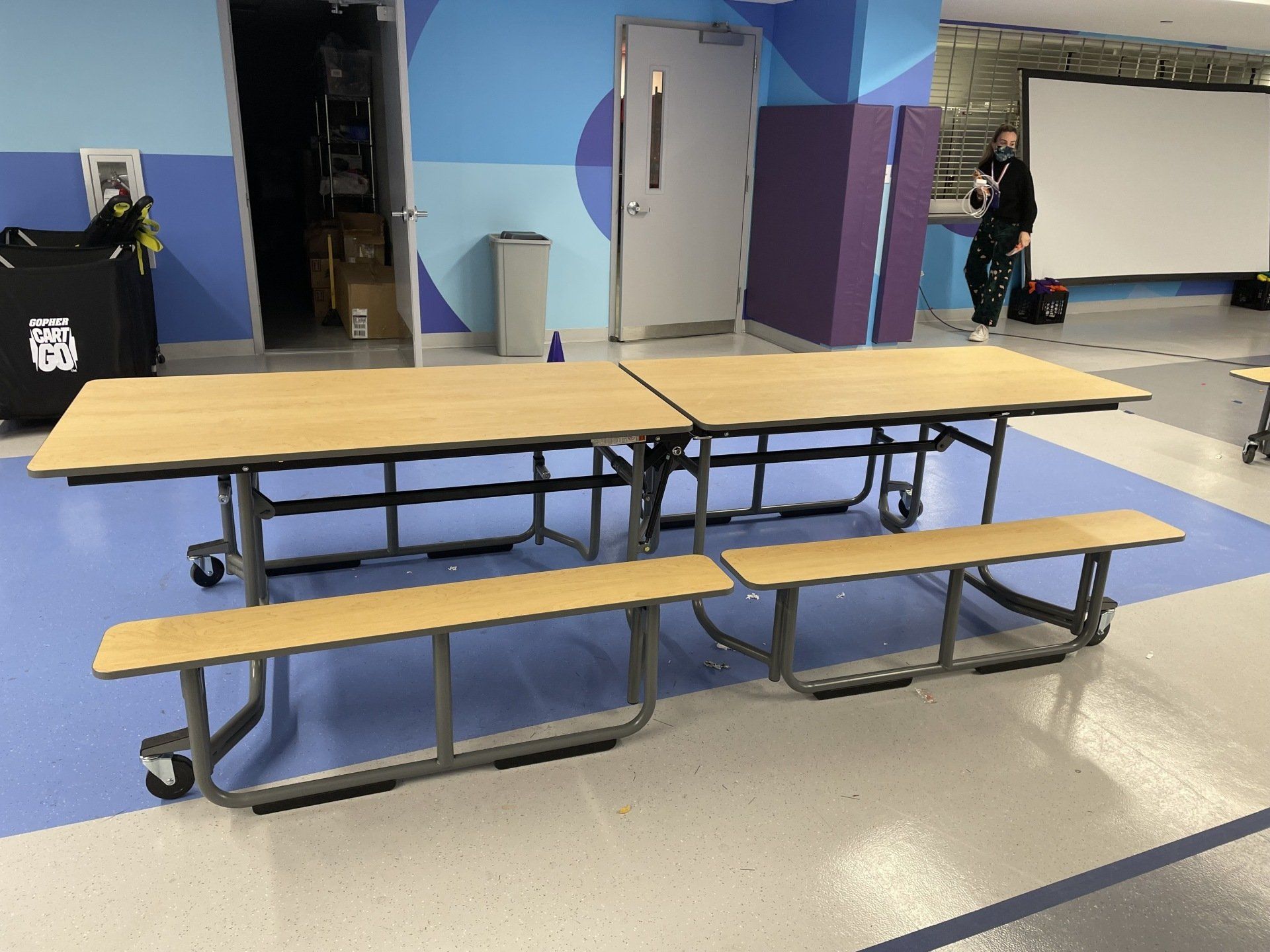 A picnic table with two benches in a room