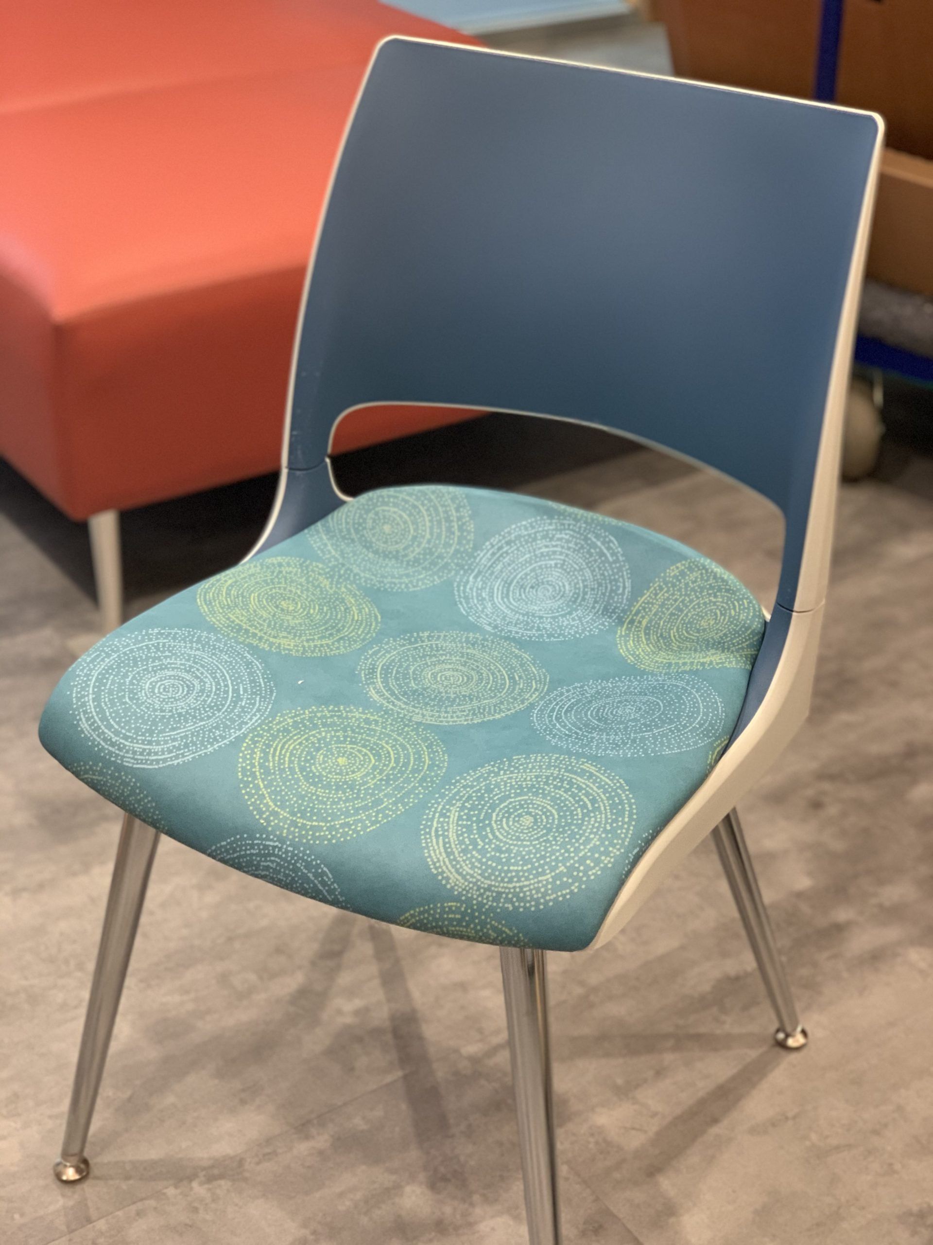 A blue and white chair with a blue cushion