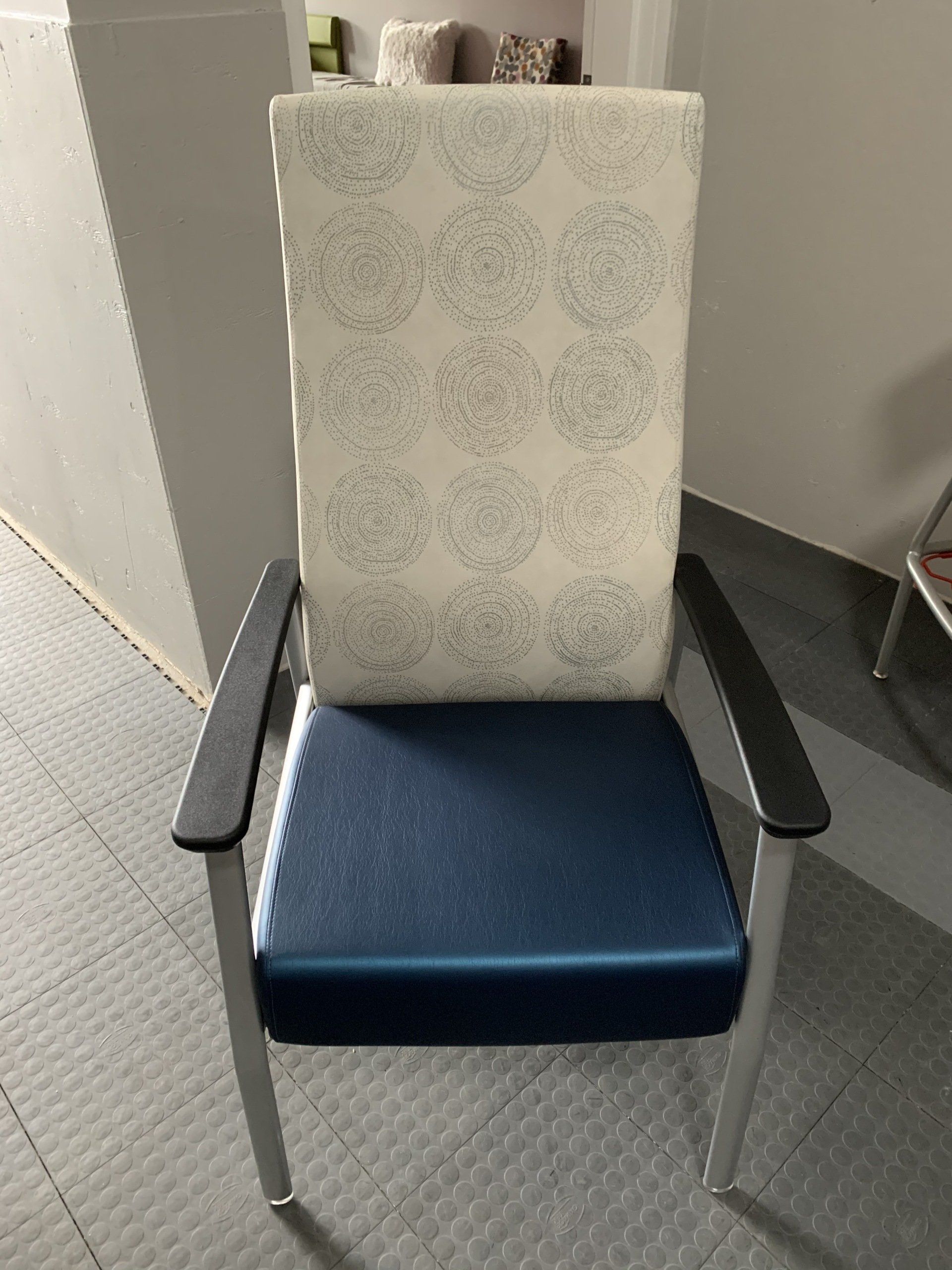 A blue chair with a white cushion on the back