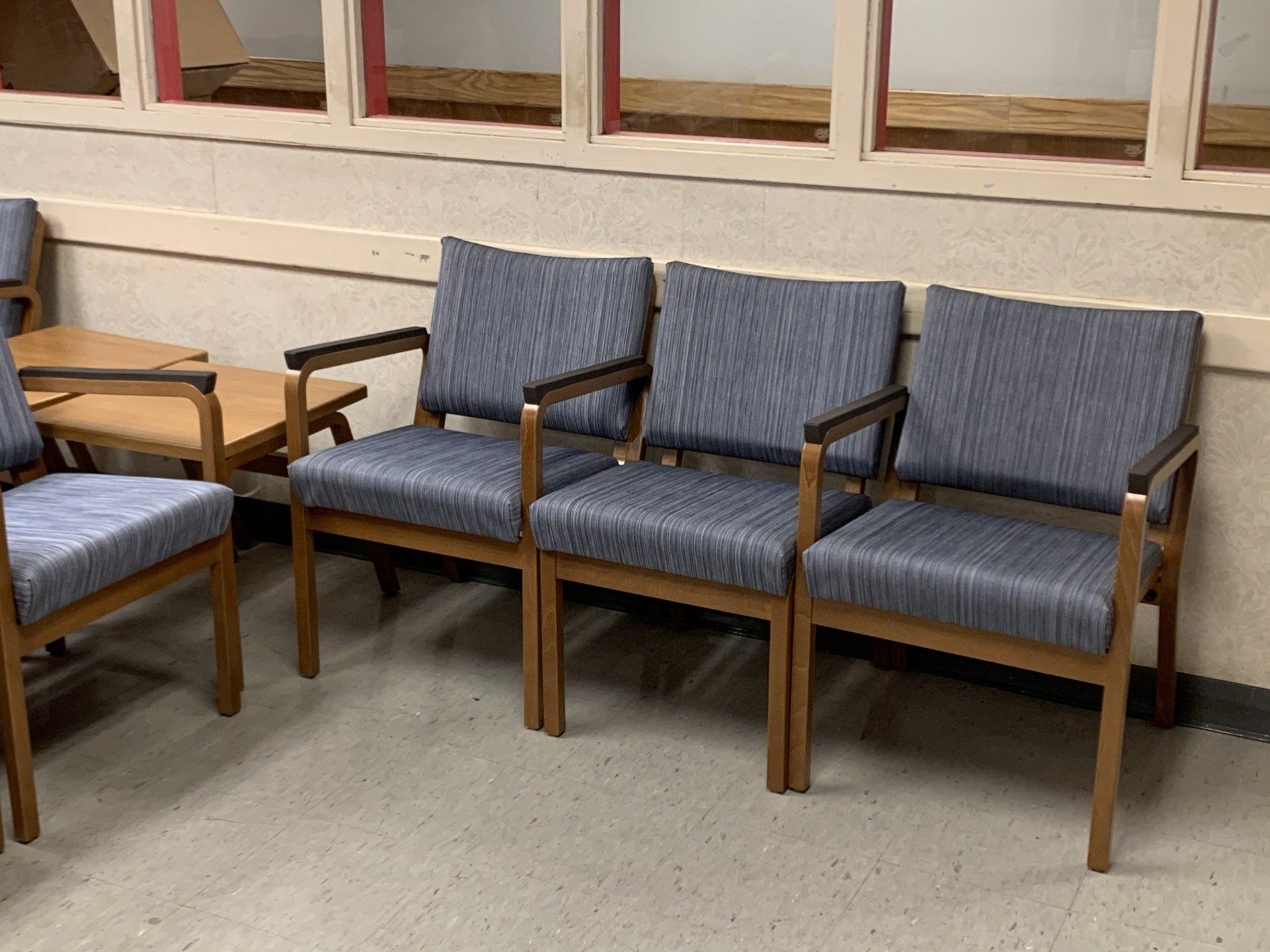 A row of chairs are lined up in a waiting room.