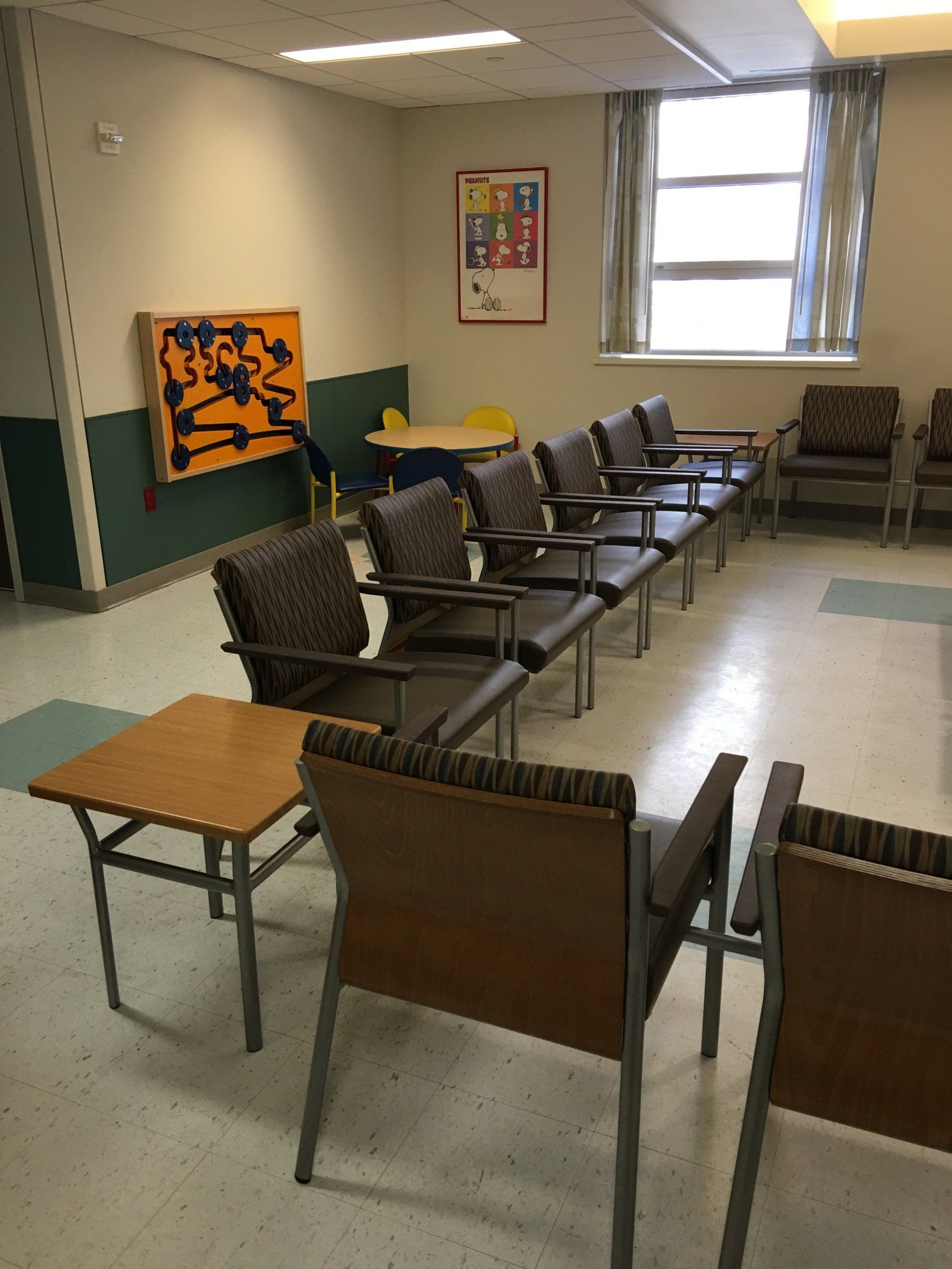 A waiting room with chairs and a table