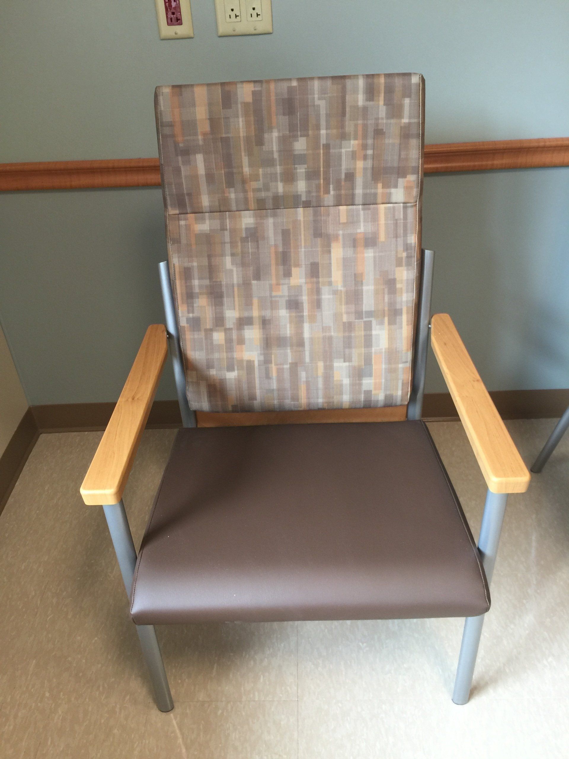 A chair with a wooden back sits in a room