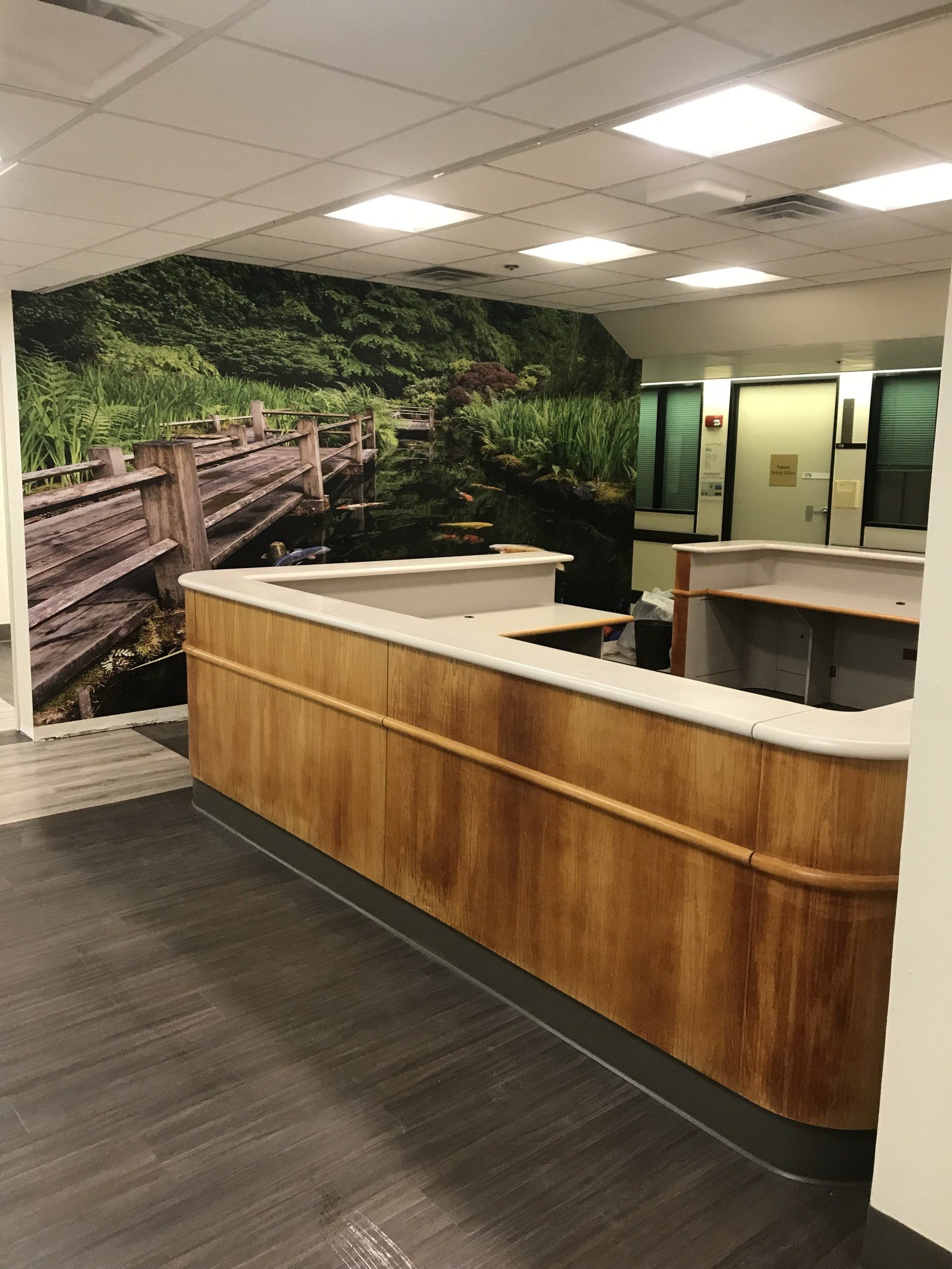 A reception desk with a picture on the wall behind it