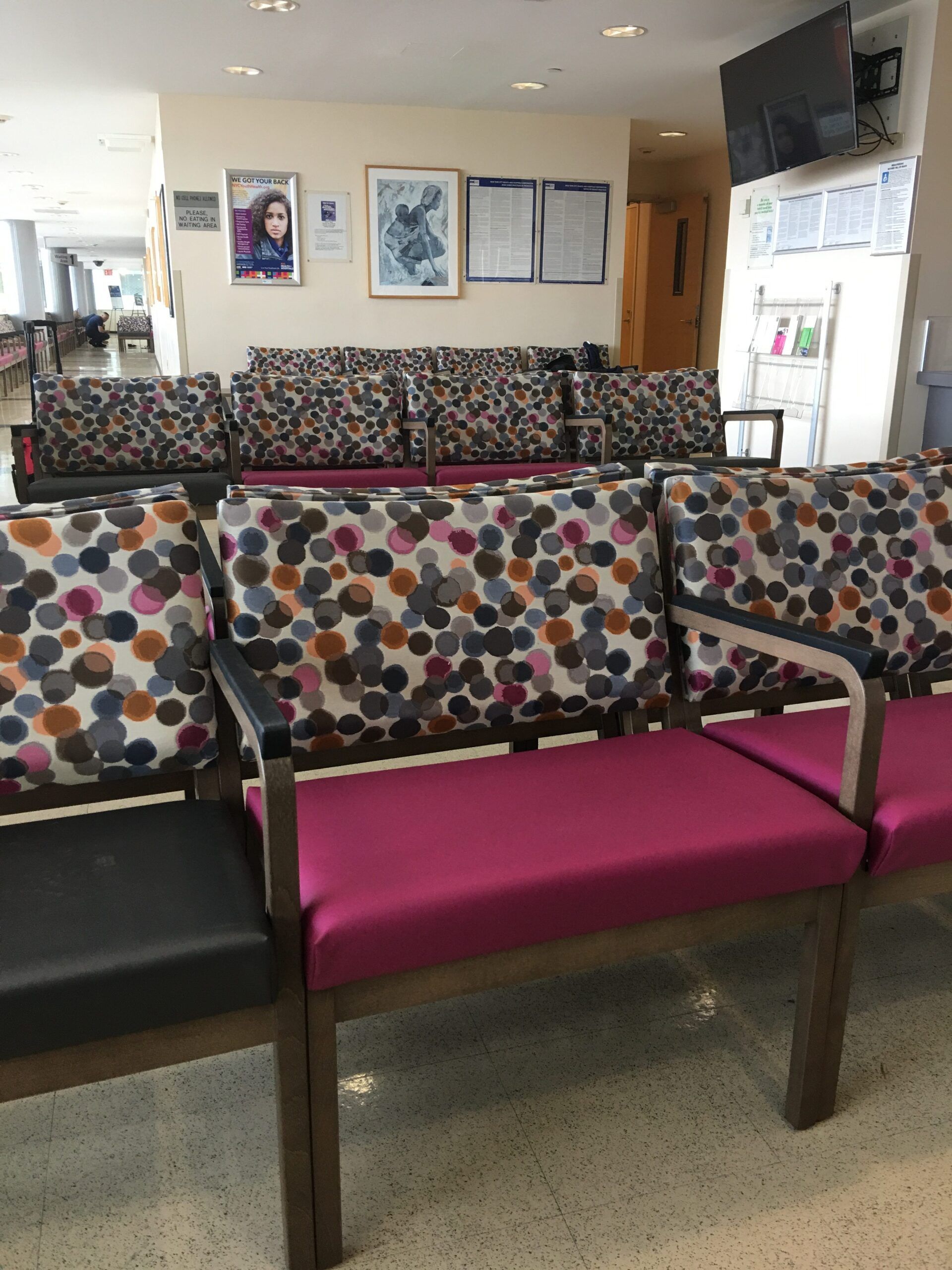 A waiting room with colorful chairs and a couch