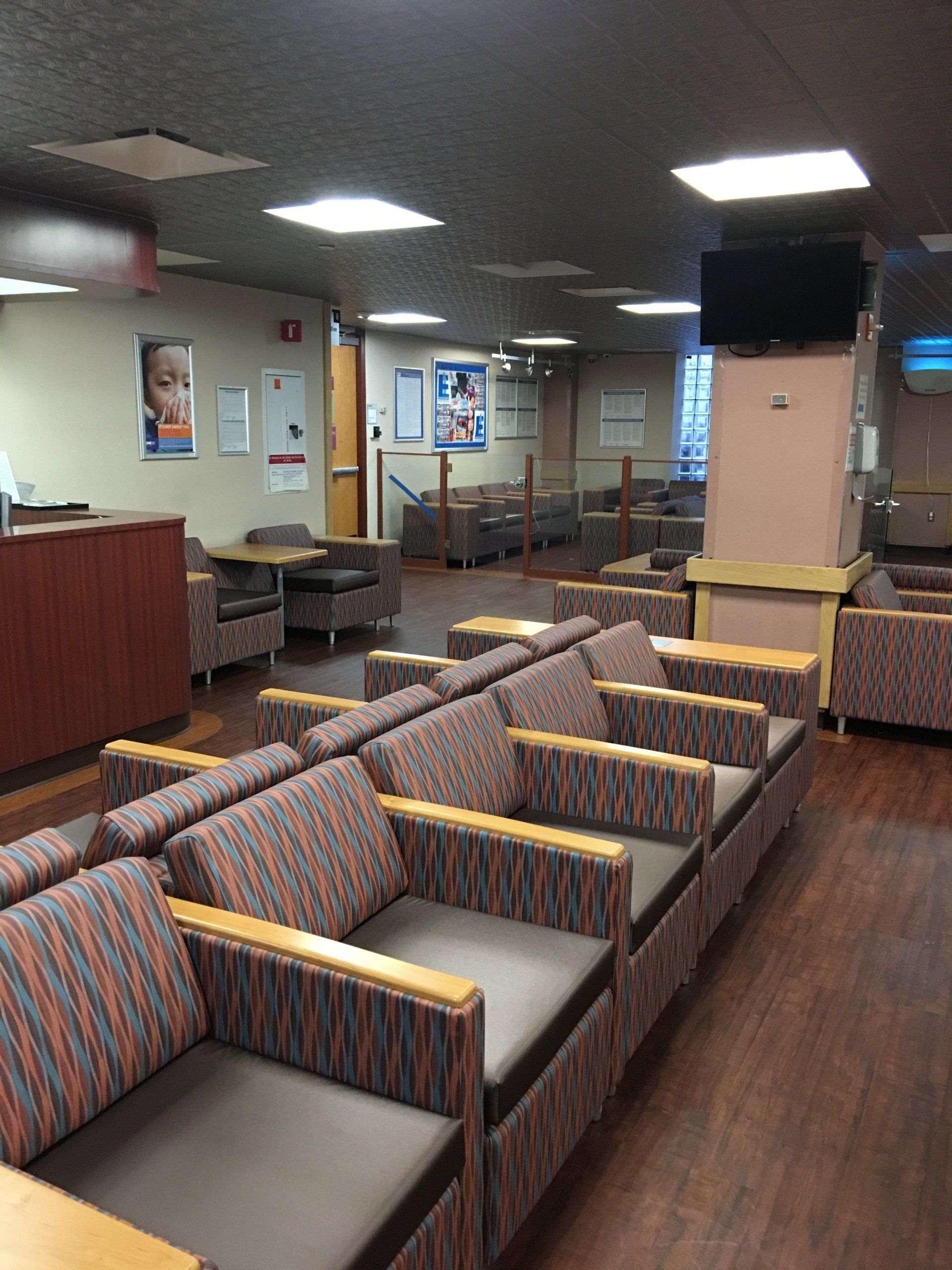 A waiting room with a lot of chairs and tables